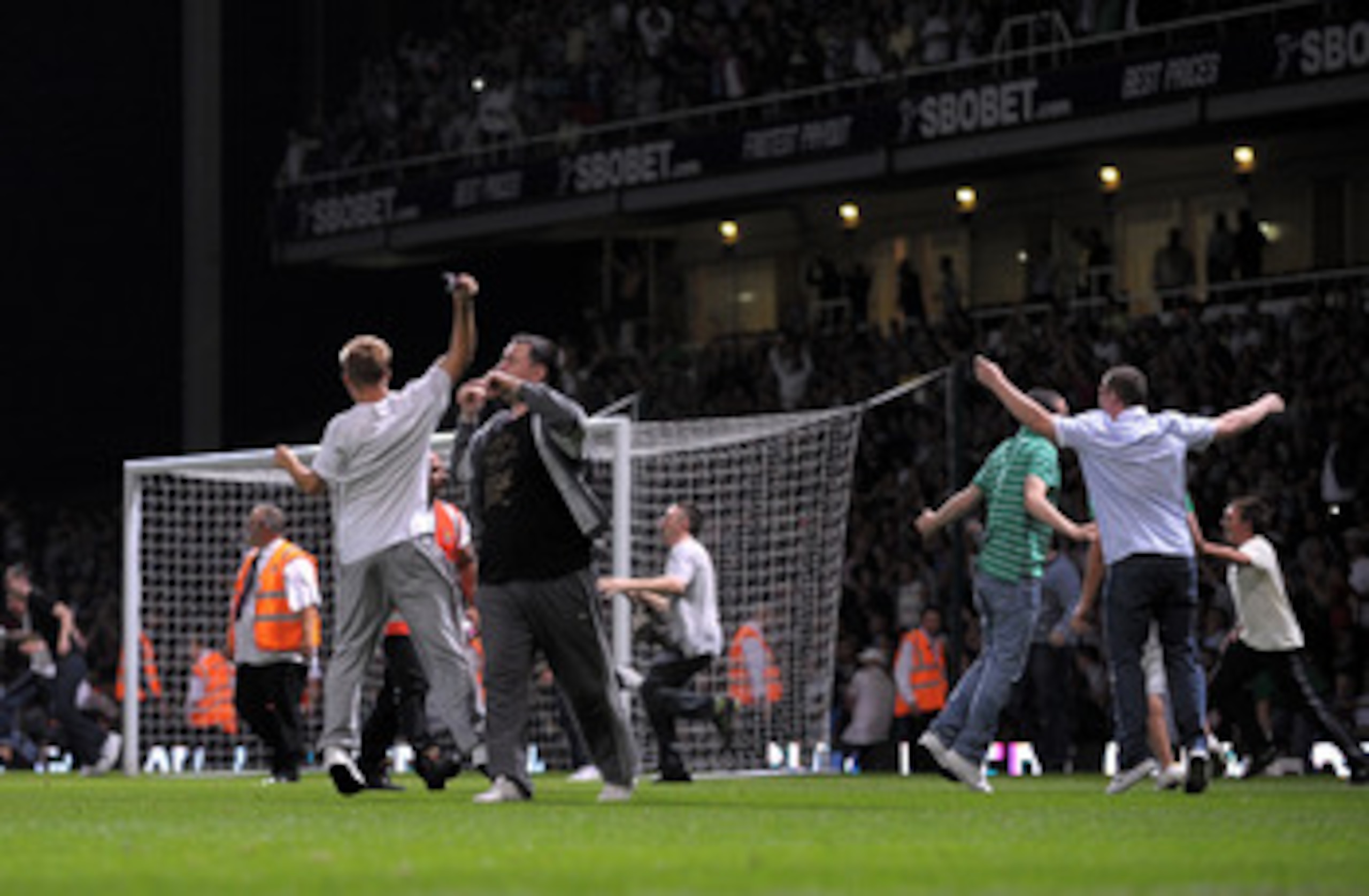 LONDON, ENGLAND - AUGUST 25:  Fans invade the pitch during the Carling Cup second round match between West Ham United and Millwall at Upton Park on August 25, 2009 in London, England.  . Violence broke out between West Ham and Millwall supporters, prior t