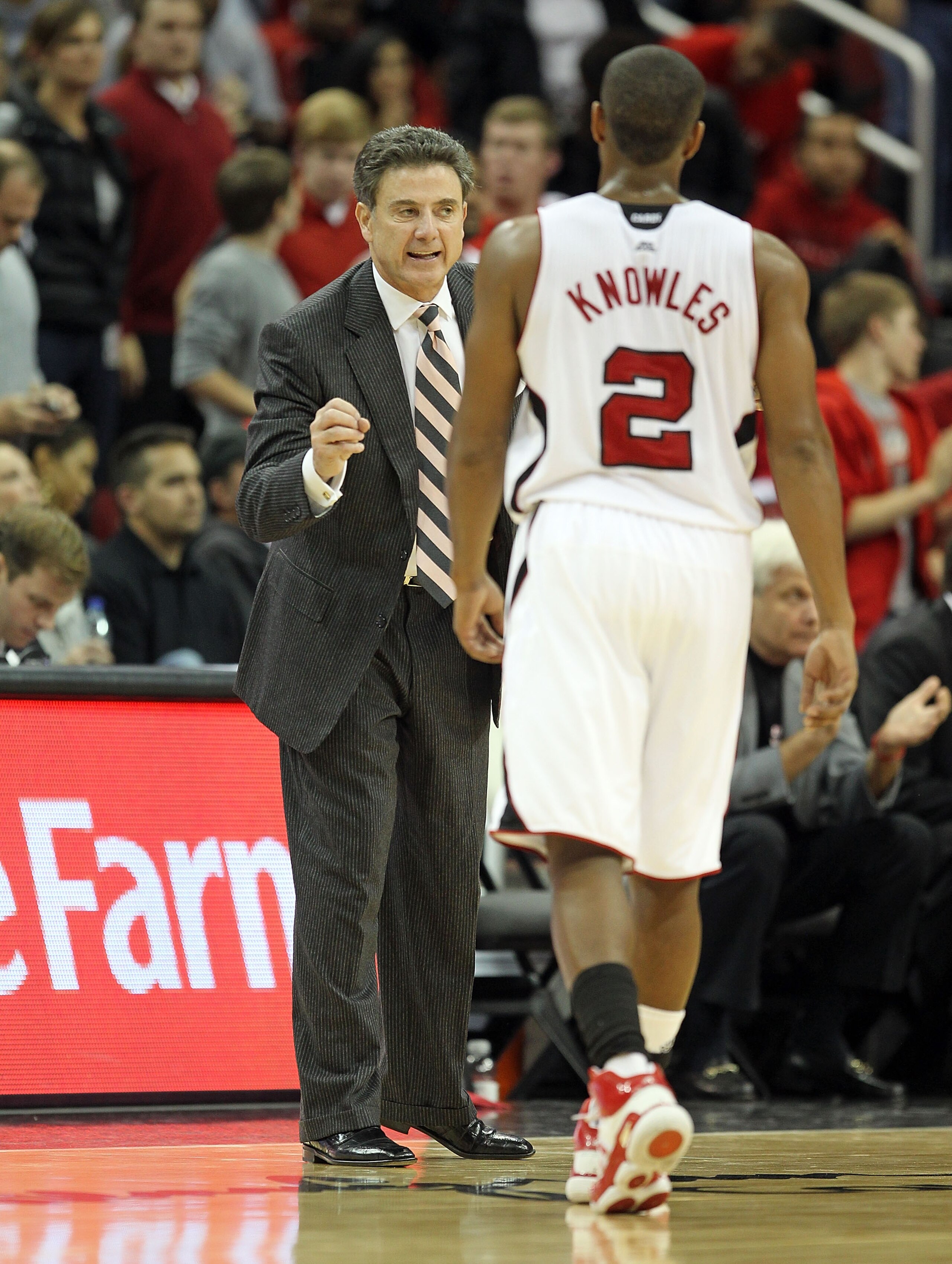 LOUISVILLE, KY - NOVEMBER 16:  Rick Pitino the Head Coach of the Louisville Cardinals gives instructions Preston Knowles #2 during the game against the Butler Bulldogs at the KFC Yum! Center on November 16, 2010 in Louisville, Kentucky.  (Photo by Andy Ly