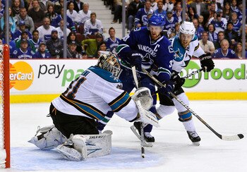 VANCOUVER, CANADA - MAY 24:  Joe Pavelski #8 of the San Jose Sharks defends Henrik Sedin #33 of the Vancouver Canucks as goaltender Antti Niemi #31 of the San Jose Sharks makes a save in Game Five of the Western Conference Finals during the 2011 Stanley C