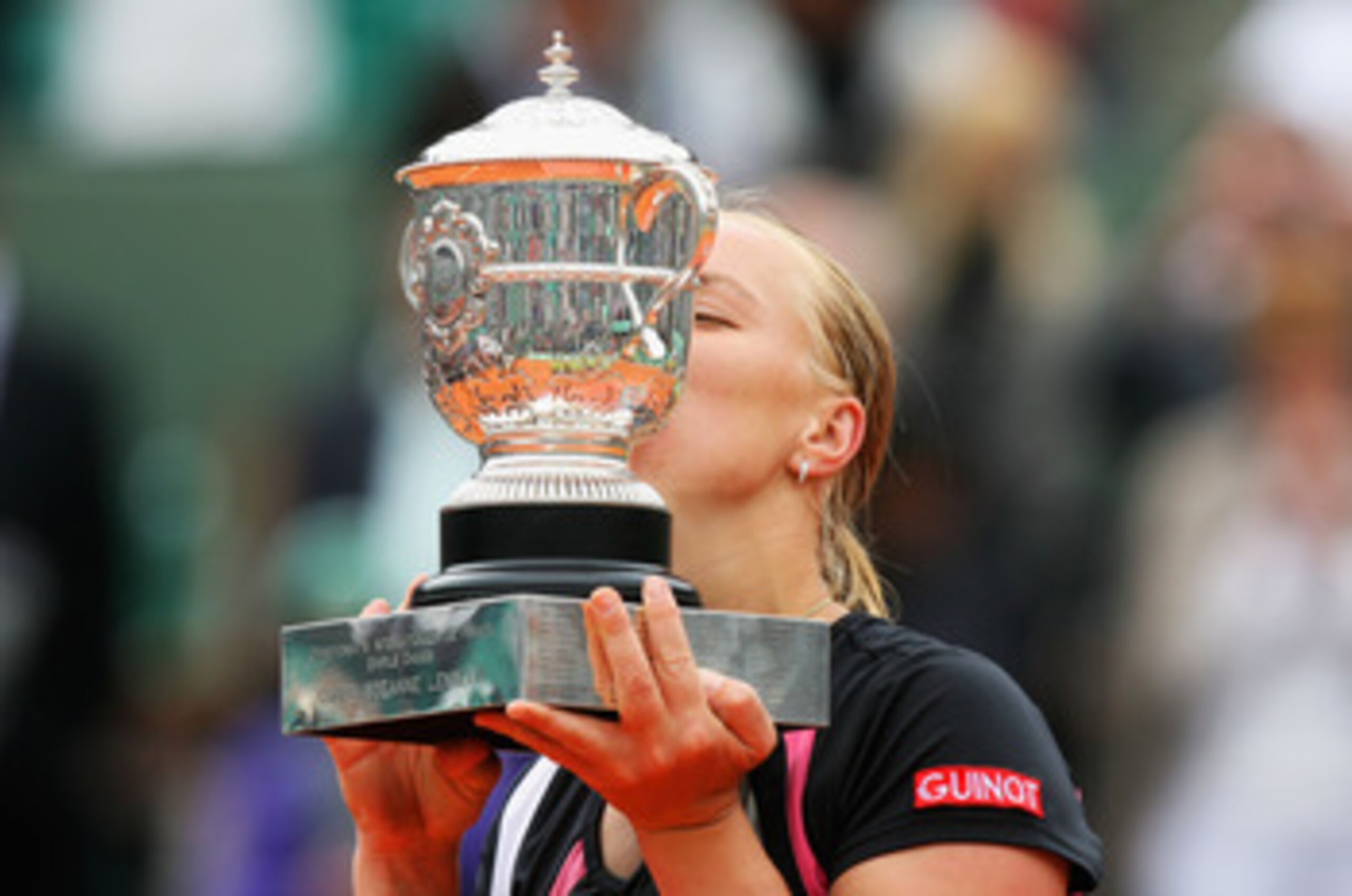 PARIS - JUNE 06:  Svetlana Kuznetsova of Russia kisses the trophy following her victory with the trophy during the Women's Singles Final match against Dinara Safina of Russia on day fourteen of the French Open at Roland Garros on June 6, 2009 in Paris, Fr