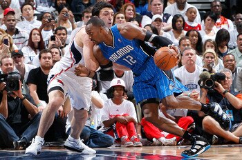 ATLANTA, GA - APRIL 22:  Dwight Howard #12 of the Orlando Magic against Zaza Pachulia #27 of the Atlanta Hawks during Game Three of the Eastern Conference Quarterfinals in the 2011 NBA Playoffs at Philips Arena on April 22, 2011 in Atlanta, Georgia.  NOTE