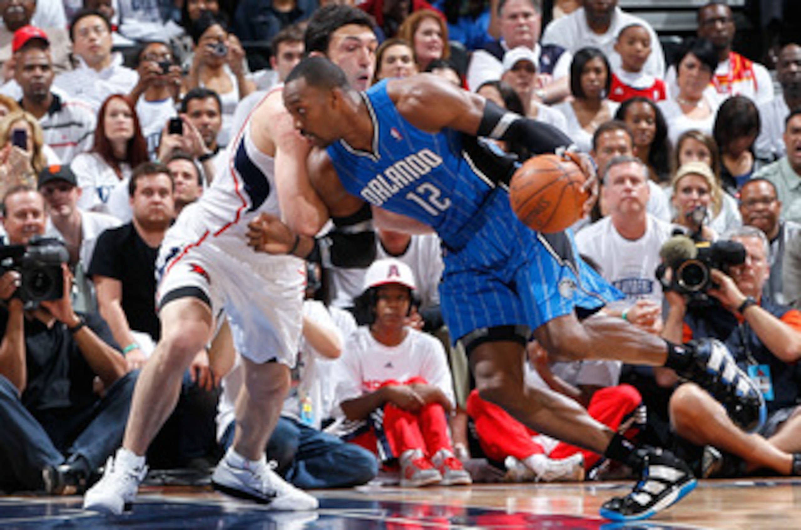 ATLANTA, GA - APRIL 22:  Dwight Howard #12 of the Orlando Magic against Zaza Pachulia #27 of the Atlanta Hawks during Game Three of the Eastern Conference Quarterfinals in the 2011 NBA Playoffs at Philips Arena on April 22, 2011 in Atlanta, Georgia.  NOTE
