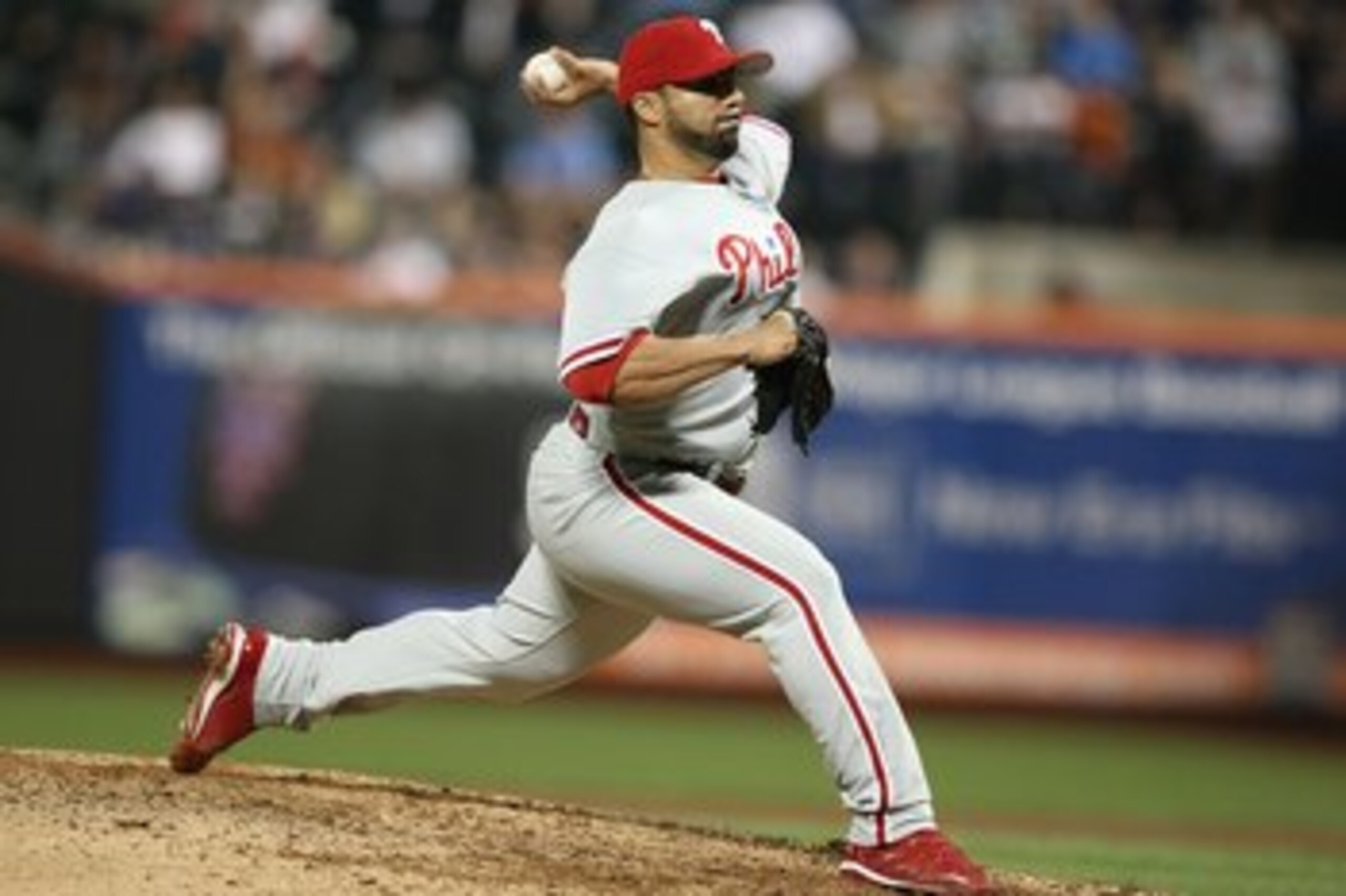 NEW YORK - JUNE 10:  J.C. Romero #16 of the Philadelphia Phillies pitches against  the New York Metsduring their game on June 10, 2009 at Citi Field in the Flushing neighborhood of the Queens borough of New York City.  (Photo by Al Bello/Getty Images)