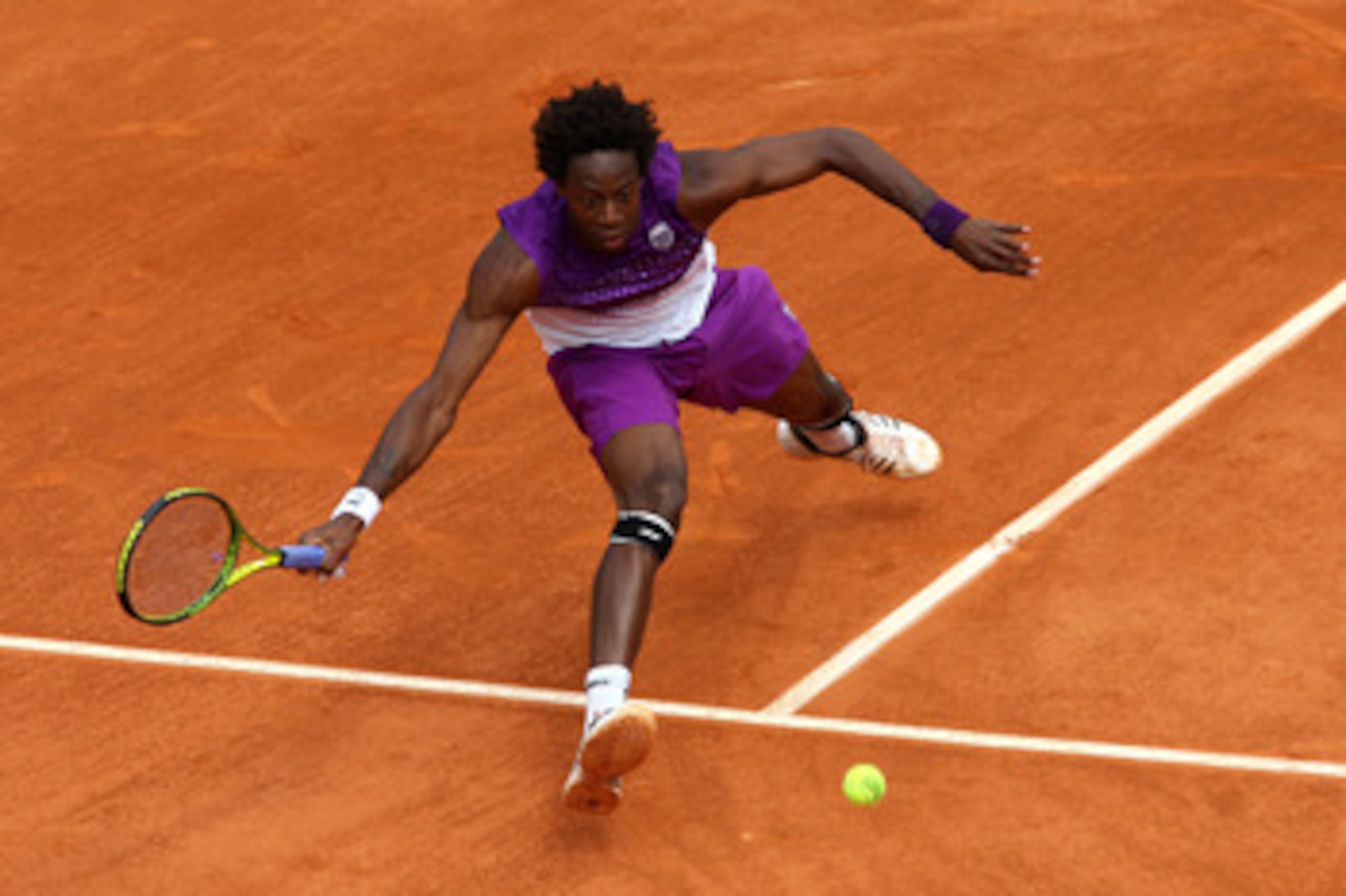 PARIS, FRANCE - MAY 27:  Gael Monfils of France stretches to hit a forehand during the men's singles round three match between Steve Darcis of Belgium and Gael Monfils of France on day six of the French Open at Roland Garros on May 27, 2011 in Paris, Fran