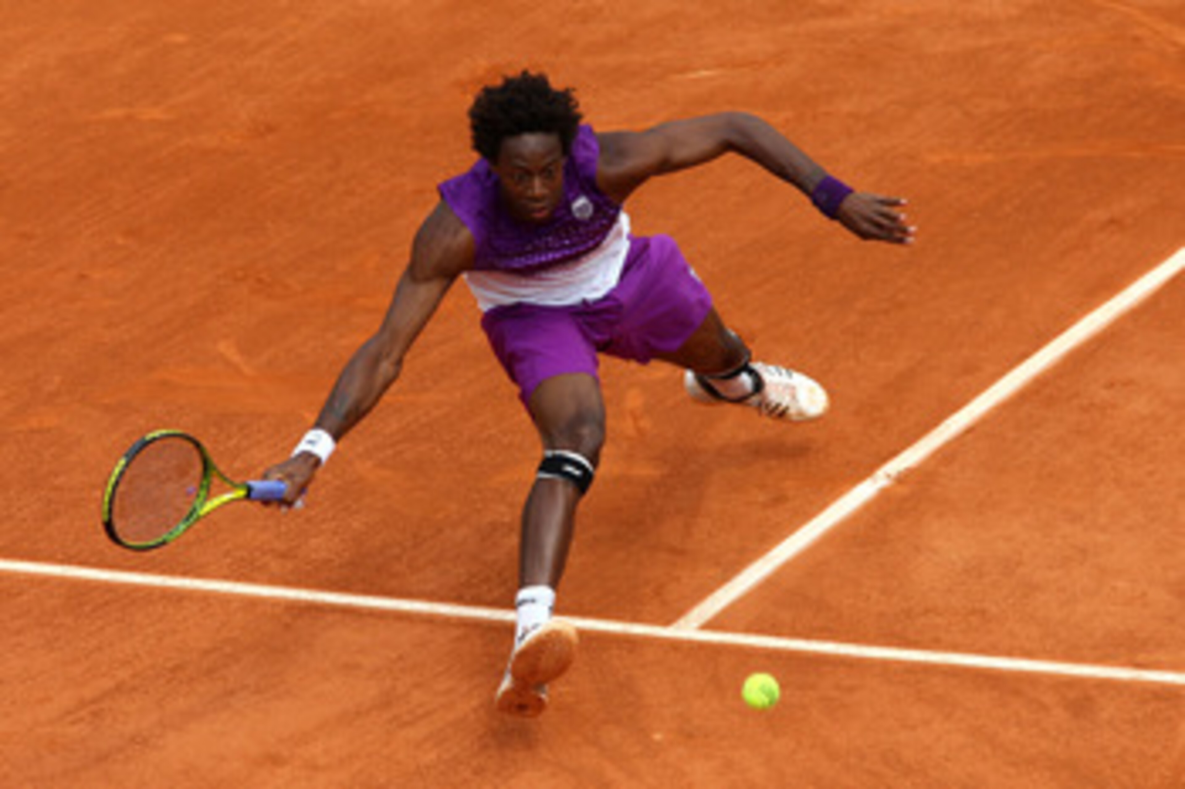 PARIS, FRANCE - MAY 27:  Gael Monfils of France stretches to hit a forehand during the men's singles round three match between Steve Darcis of Belgium and Gael Monfils of France on day six of the French Open at Roland Garros on May 27, 2011 in Paris, Fran