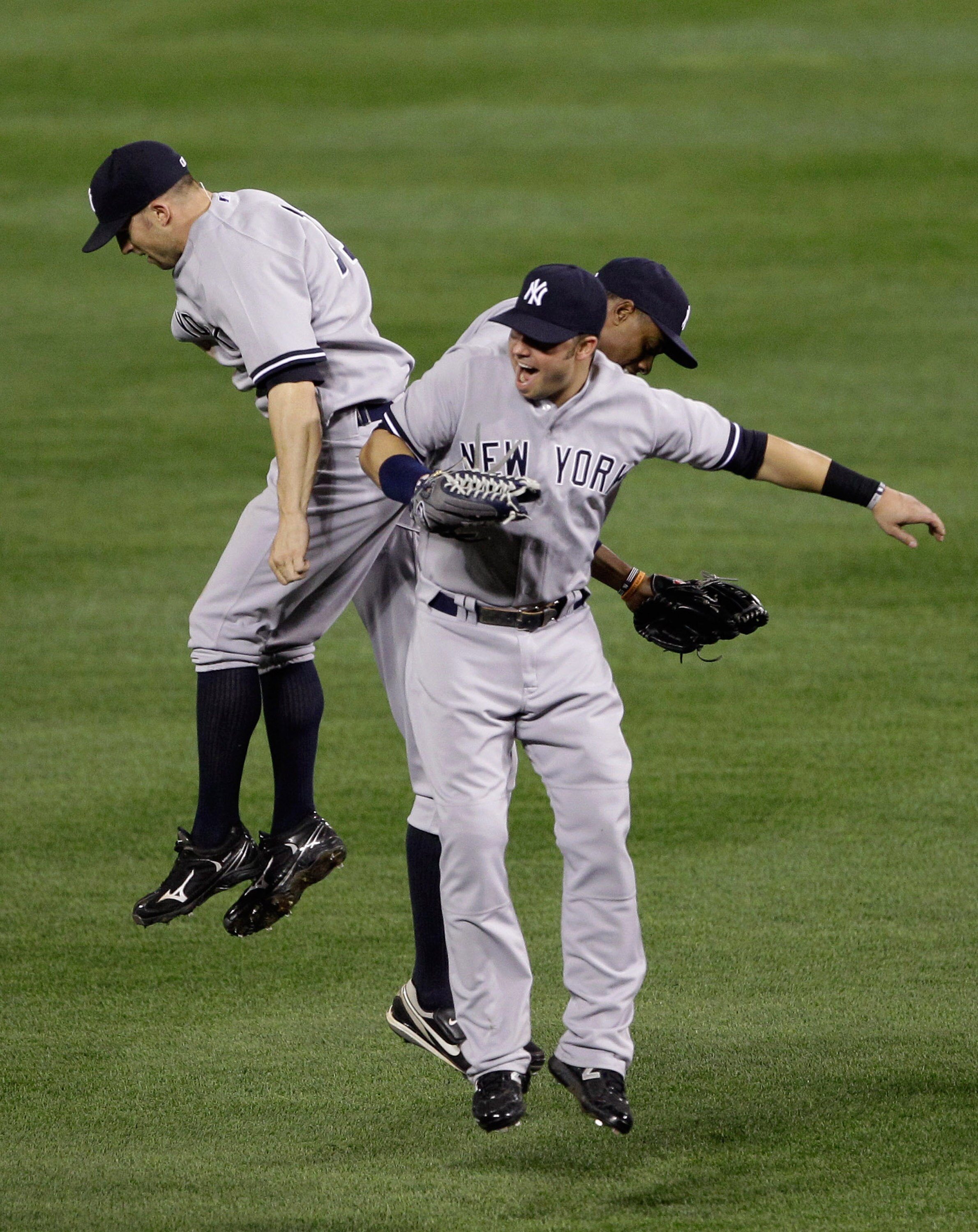 BALTIMORE, MD - APRIL 23: Outfielder Brett Gardner #11  (L), Nick Swisher #33 (C) and Curtis Granderson #14 of the New York Yankees celebrate after the Yankees defeated the Baltimore Orioles 15-3 at Oriole Park at Camden Yards on April 23, 2011 in Baltimo