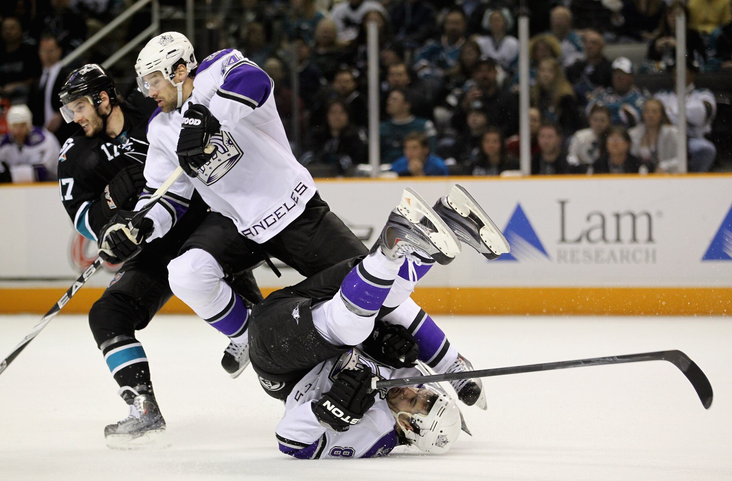 SAN JOSE, CA - APRIL 23: Drew Doughty #8 of the Los Angeles Kings falls down when he is hit by teammate Justin Williams #14 and Torrey Mitchell #17 of the San Jose Sharks in game five of the Western Conference Quarterfinals during the 2011 NHL Stanley Cu SAN JOSE, CA - APRIL 23: Drew Doughty #8 of the Los Angeles Kings falls down when he is hit by teammate Justin Williams #14 and Torrey Mitchell #17 of the San Jose Sharks in game five of the Western Conference Quarterfinals during the 2011 NHL Stanley Cu
