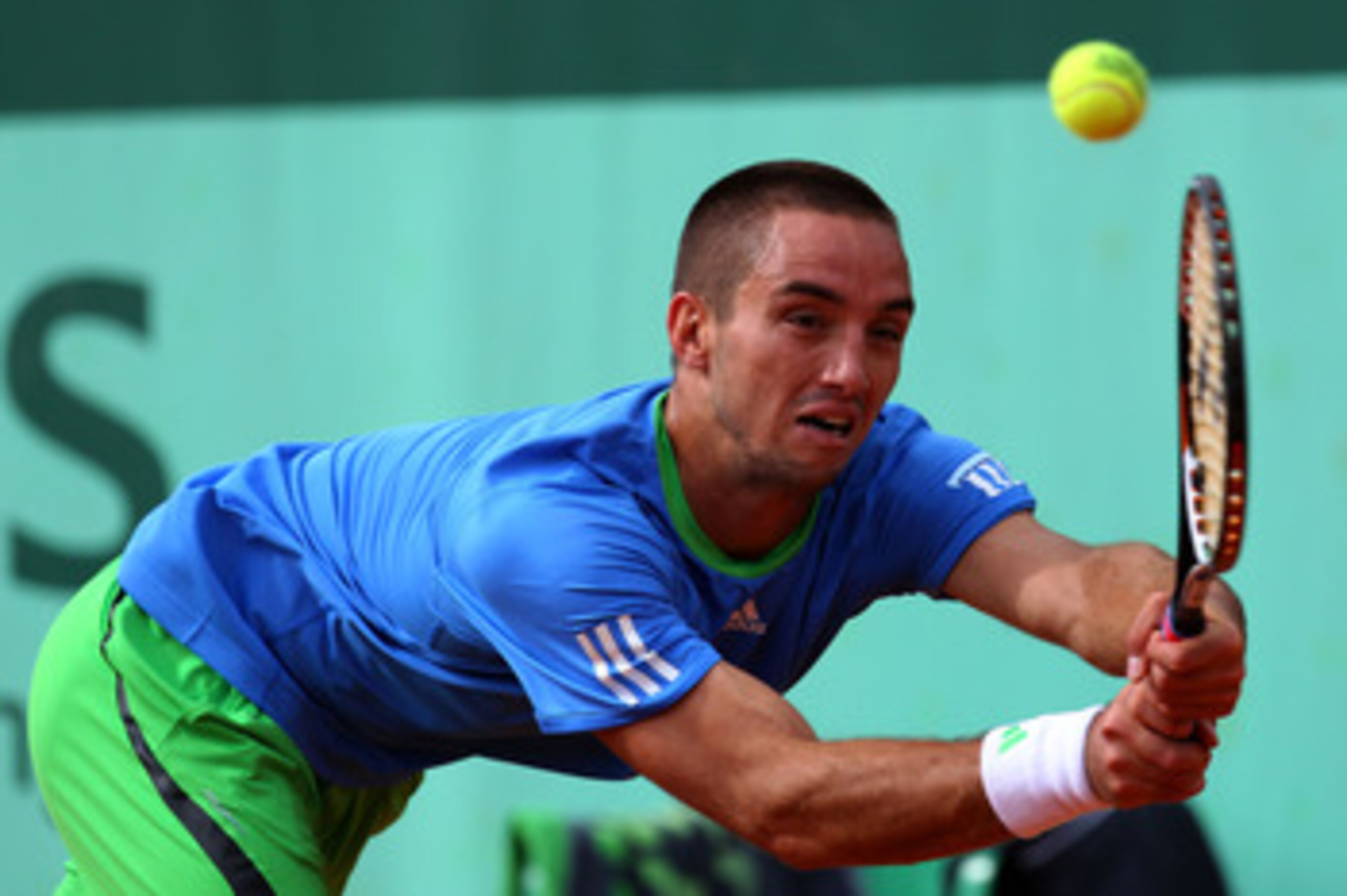 PARIS, FRANCE - MAY 26:  Viktor Troicki of Serbia hits a backhand during the men's singles round two match between Tobias Kamke of Germany and Viktor Troicki of Serbia on day five of the French Open at Roland Garros on May 26, 2011 in Paris, France.  (Pho