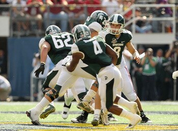 ORLANDO, FL - JANUARY 01: Kirk Cousins #8 of the Michigan State Spartans hands the ball off to Edwin Baker #4 during the Capitol One Bowl against the Alabama Crimson Tide at the Florida Citrus Bowl on January 1, 2011 in Orlando, Florida. (Photo by Mike ORLANDO, FL - JANUARY 01: Kirk Cousins #8 of the Michigan State Spartans hands the ball off to Edwin Baker #4 during the Capitol One Bowl against the Alabama Crimson Tide at the Florida Citrus Bowl on January 1, 2011 in Orlando, Florida. (Photo by Mike