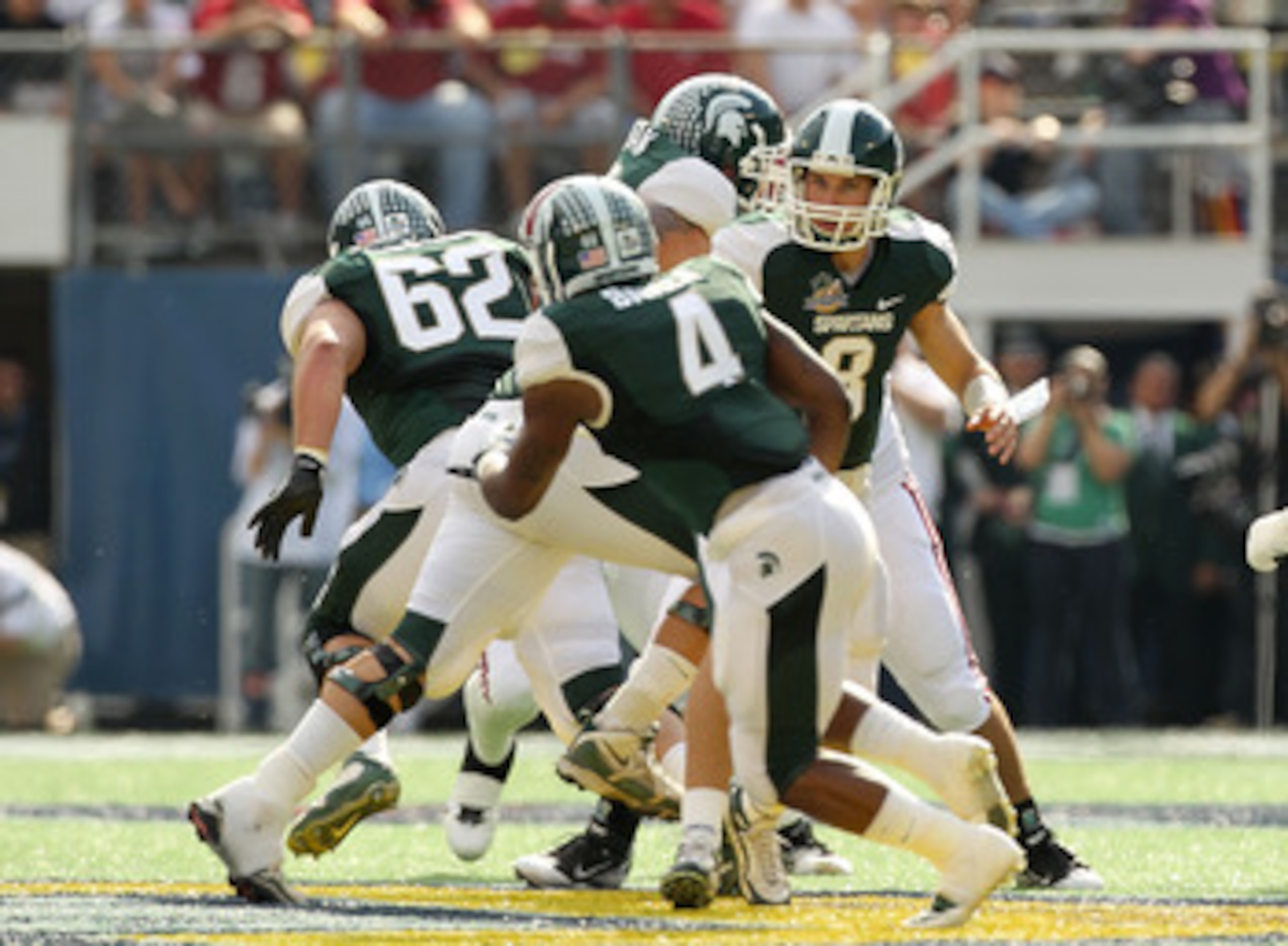 ORLANDO, FL - JANUARY 01:  Kirk Cousins #8 of the Michigan State Spartans hands the ball off to Edwin Baker #4 during the Capitol One Bowl against the Alabama Crimson Tide at the Florida Citrus Bowl on January 1, 2011 in Orlando, Florida.  (Photo by Mike 
