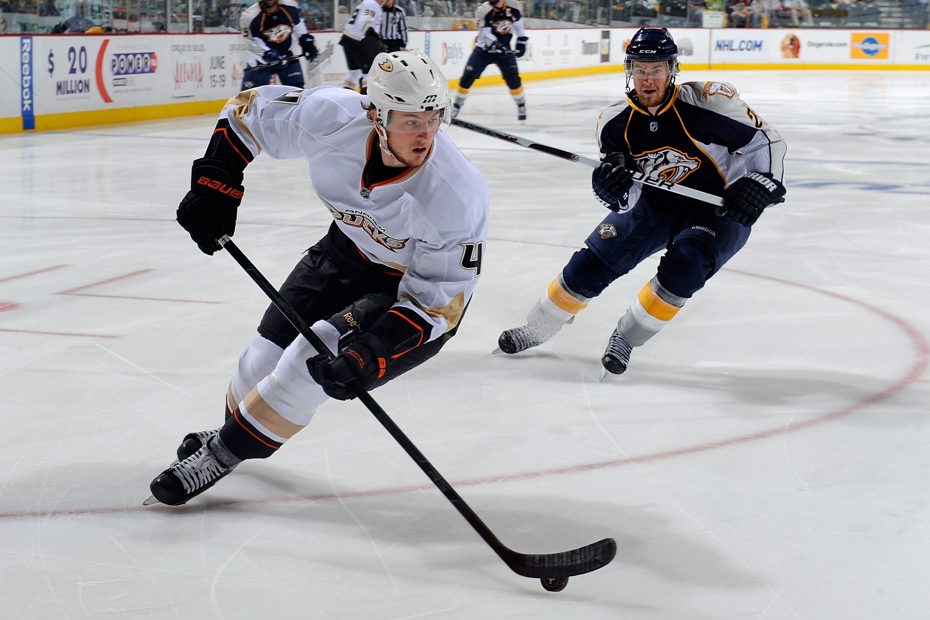 NASHVILLE, TN - APRIL 24:  Cam Fowler #4 of the Anaheim Ducks carries the puck in front of Matt Halischuk #24 of the Nashville Predators in Game Six of the Western Conference Quarterfinals during the 2011 NHL Stanley Cup Playoffs at Bridgestone Arena on A