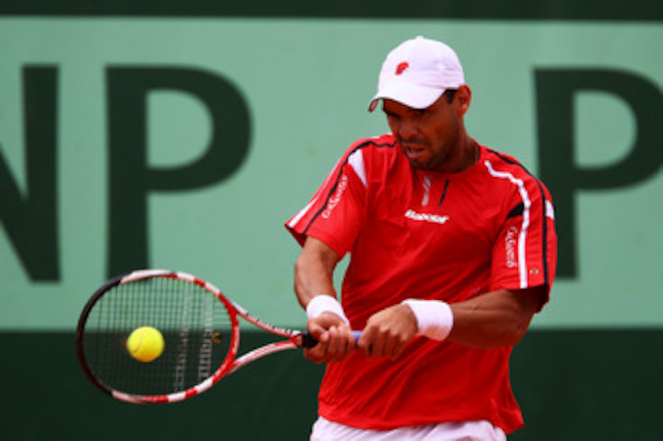 PARIS, FRANCE - MAY 26:  Alejandro Falla of Columbia hits a backhand during the men's singles round two match between Alejandro Falla of Columbia and Florian Mayer of Germany on day five of the French Open at Roland Garros on May 26, 2011 in Paris, France