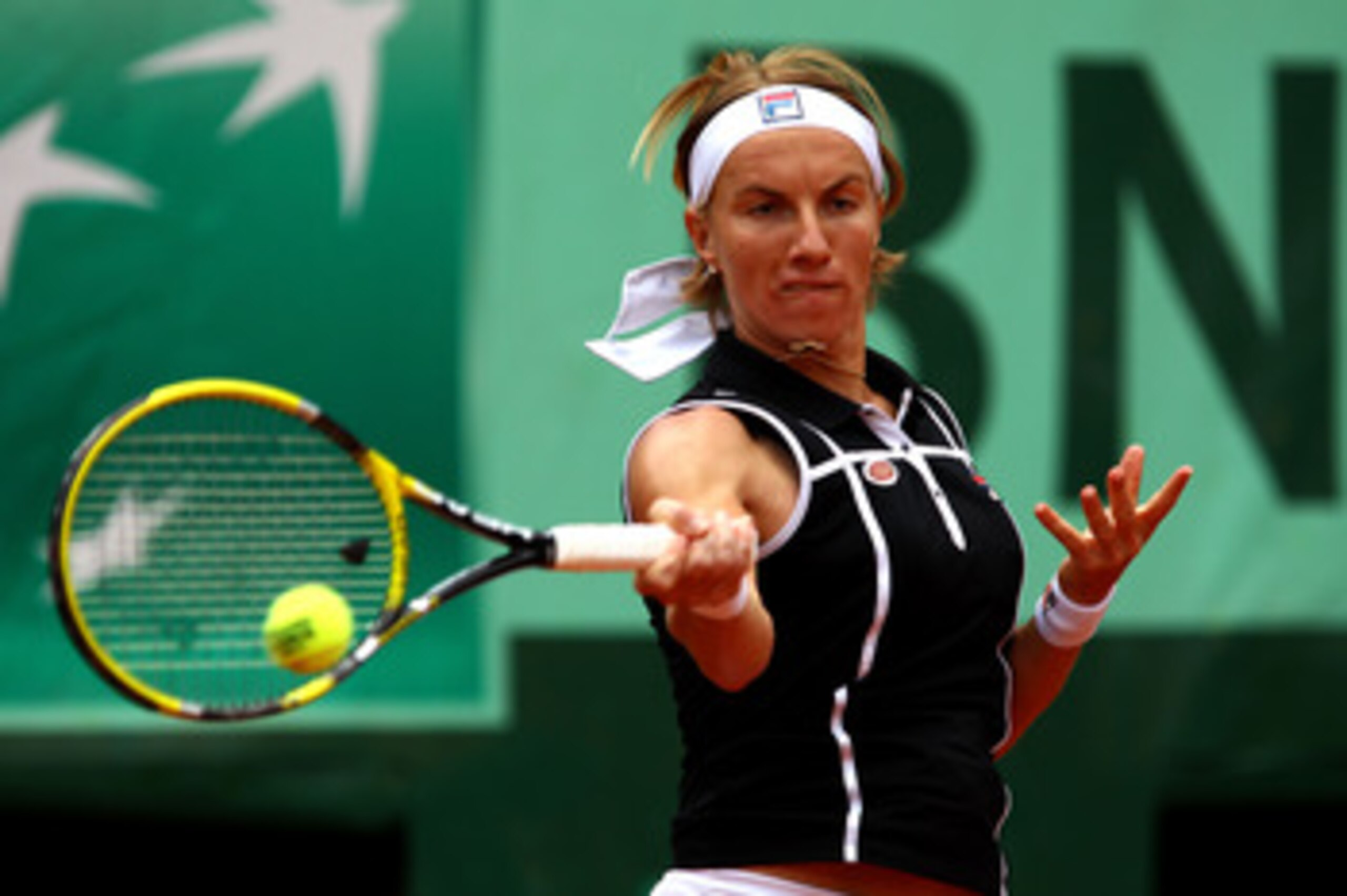 PARIS, FRANCE - MAY 27:  Svetlana Kuznetsova of Russia hits a forehand during the women's singles round three match between Rebecca Marino of Canada and Svetlana Kuznetsova of Russia on day six of the French Open at Roland Garros on May 27, 2011 in Paris,