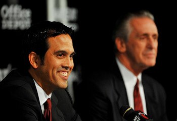MIAMI - JULY 09:  Head coach Erik Spoelstra (L) and President Pat Riley (R) of the Miami Heat talk during a press conference after a welcome party for new teammates LeBron James, Dwyane Wade, and Chris Bosh at American Airlines Arena on July 9, 2010 in Mi