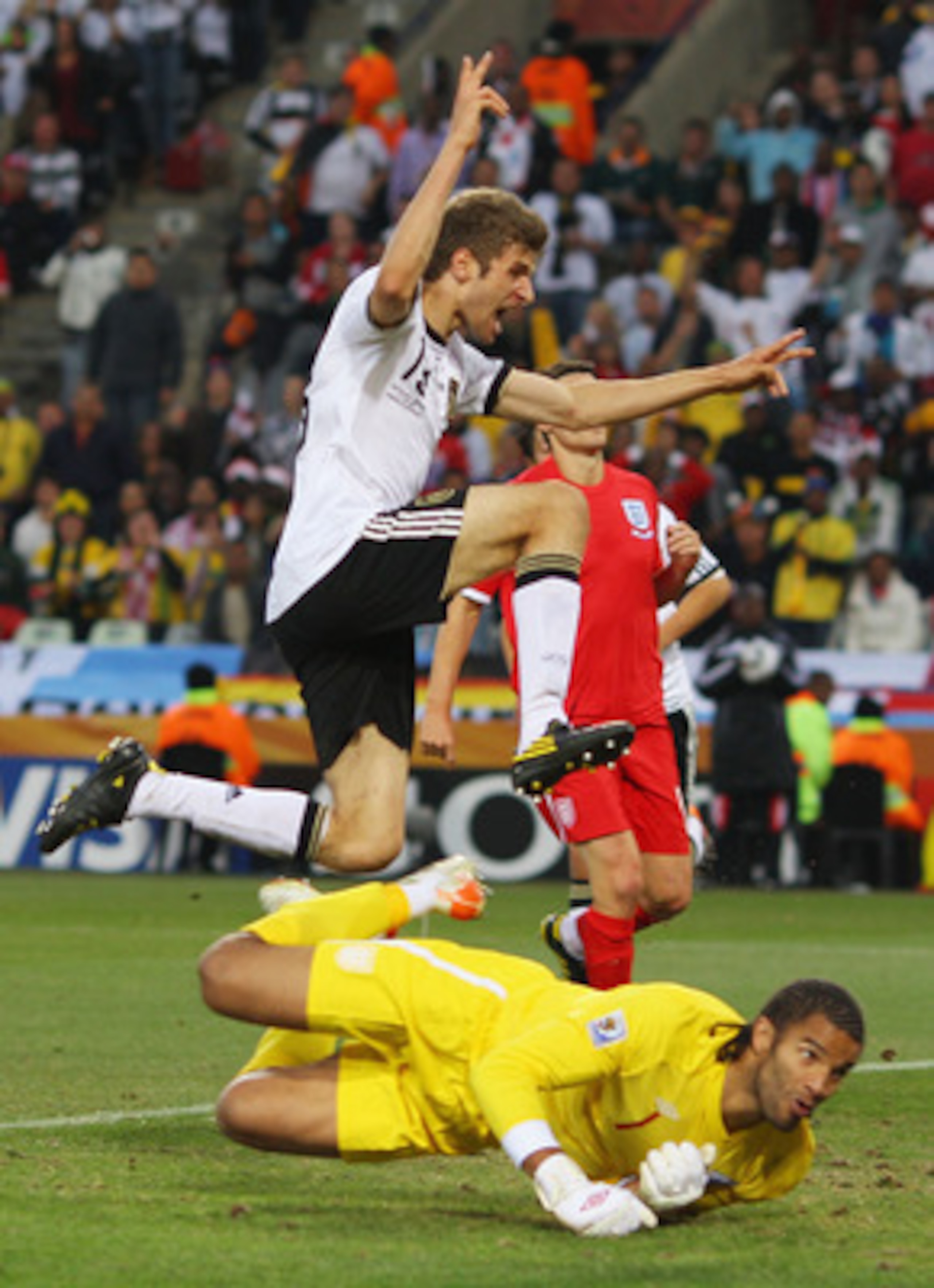 BLOEMFONTEIN, SOUTH AFRICA - JUNE 27:  Thomas Mueller of Germany celebrates scoring his teams fourth past goal David James of England during the 2010 FIFA World Cup South Africa Round of Sixteen match between Germany and England at Free State Stadium on J