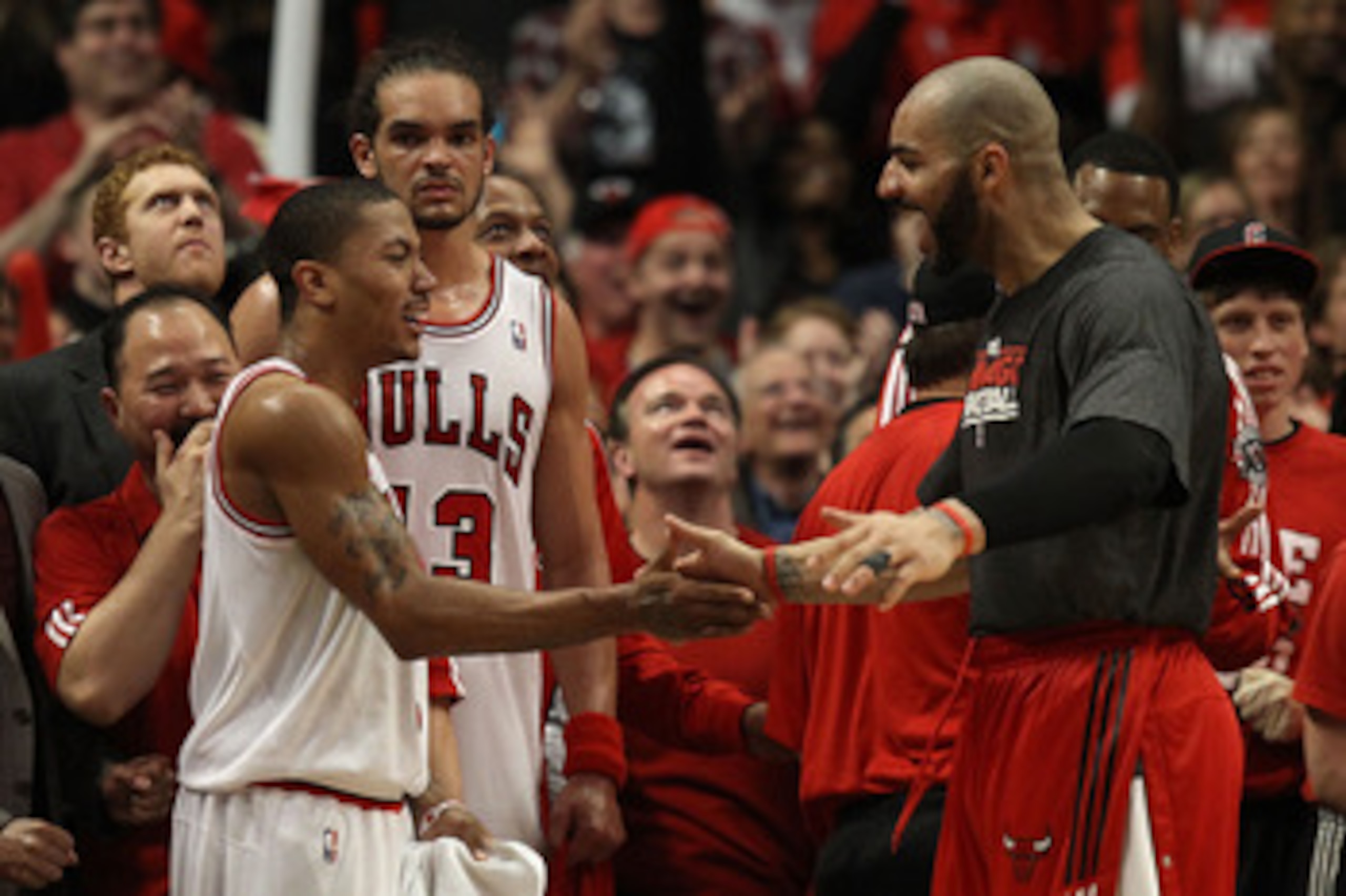 CHICAGO, IL - MAY 15: (L-R) Derrick Rose #1, Joakim Noah #13 and Carlos Boozer #5 of the Chicago Bulls celebrate late in the fourth quarter against the Miami Heat in Game One of the Eastern Conference Finals during the 2011 NBA Playoffs on May 15, 2011 at