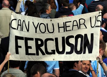 MANCHESTER, ENGLAND - MAY 23: Manchester City fans display a banner during the Manchester City FA Cup Winners Parade at Manchester Town Hall on May 23, 2011 in Manchester, United Kingdom.  (Photo by Chris Brunskill/Getty Images)
