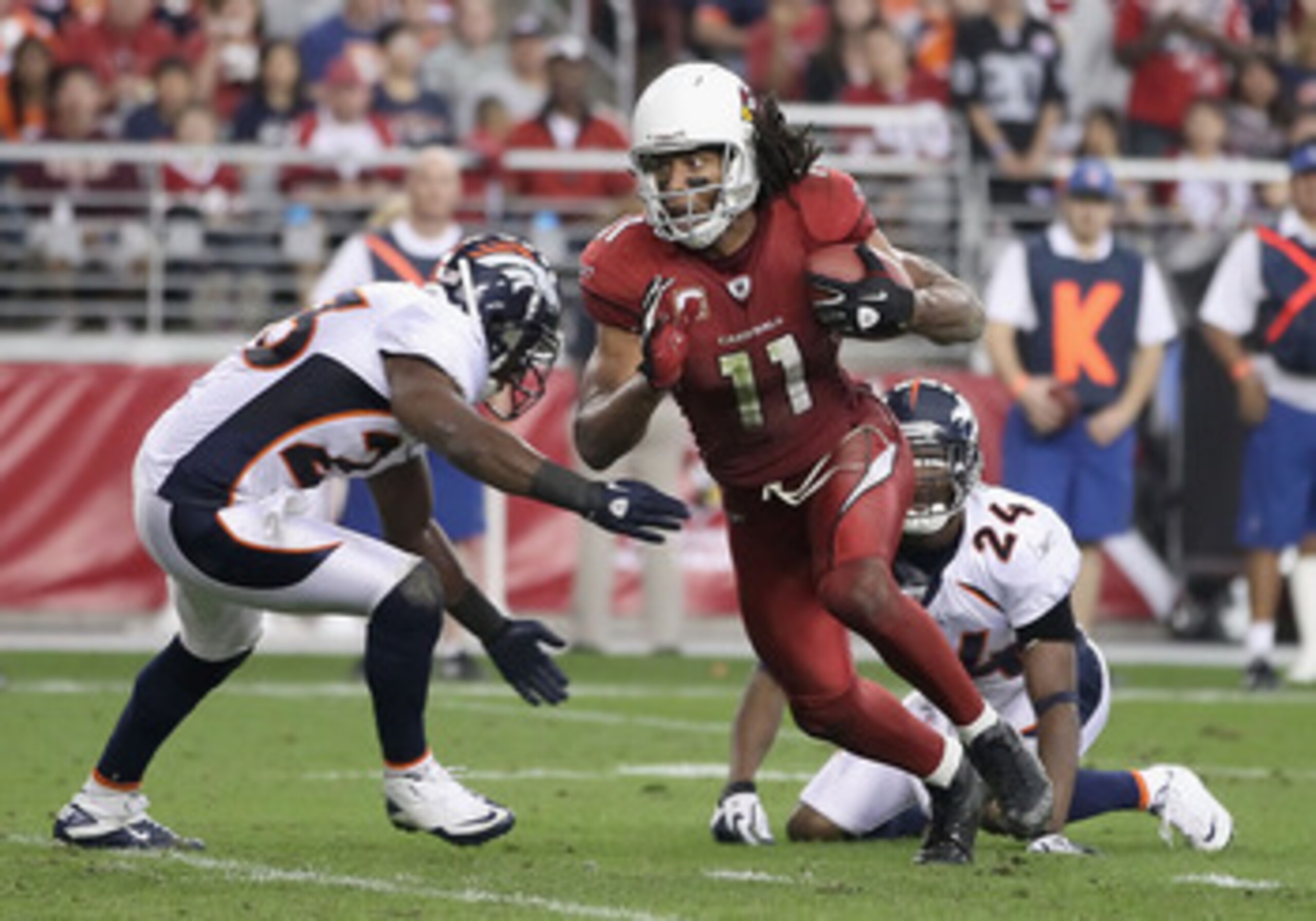 GLENDALE, AZ - DECEMBER 12: Wide receiver Larry Fitzgerald #11 of the Arizona Cardinals runs with the football after a reception during the NFL game against the Denver Broncos at the University of Phoenix Stadium on December 12, 2010 in Glendale, Arizona GLENDALE, AZ - DECEMBER 12: Wide receiver Larry Fitzgerald #11 of the Arizona Cardinals runs with the football after a reception during the NFL game against the Denver Broncos at the University of Phoenix Stadium on December 12, 2010 in Glendale, Arizona