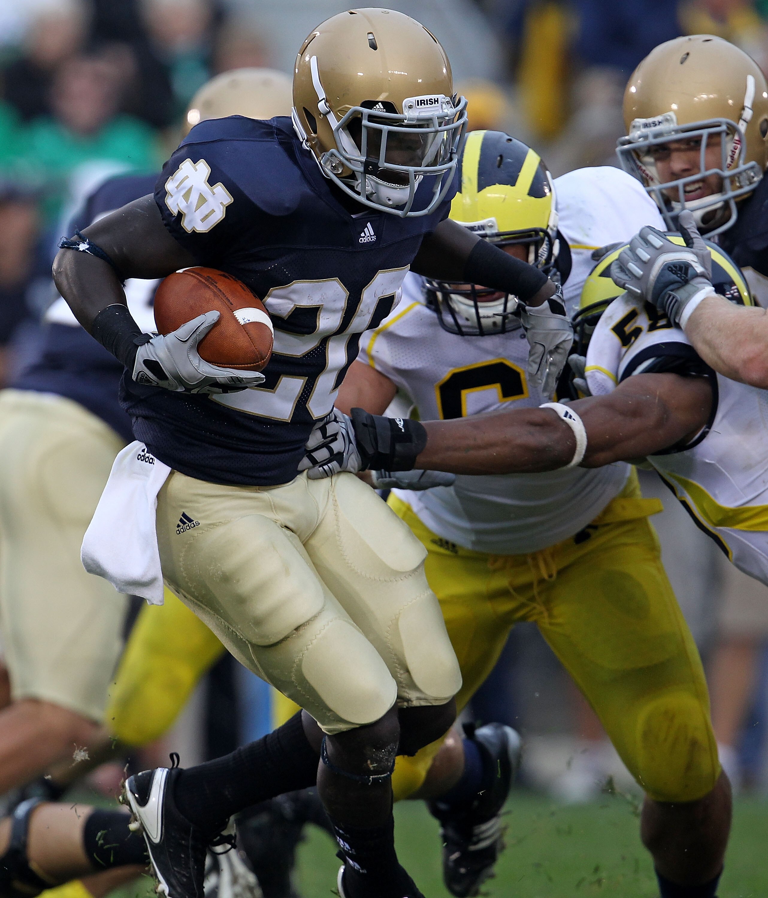 SOUTH BEND, IN - SEPTEMBER 11: Cierre Wood #20 of the Notre Dame Fighting Irish fights off Michigan Wolverine tacklers at Notre Dame Stadium on September 11, 2010 in South Bend, Indiana. Michigan defeated Notre Dame 28-24. (Photo by Jonathan Daniel/Getty