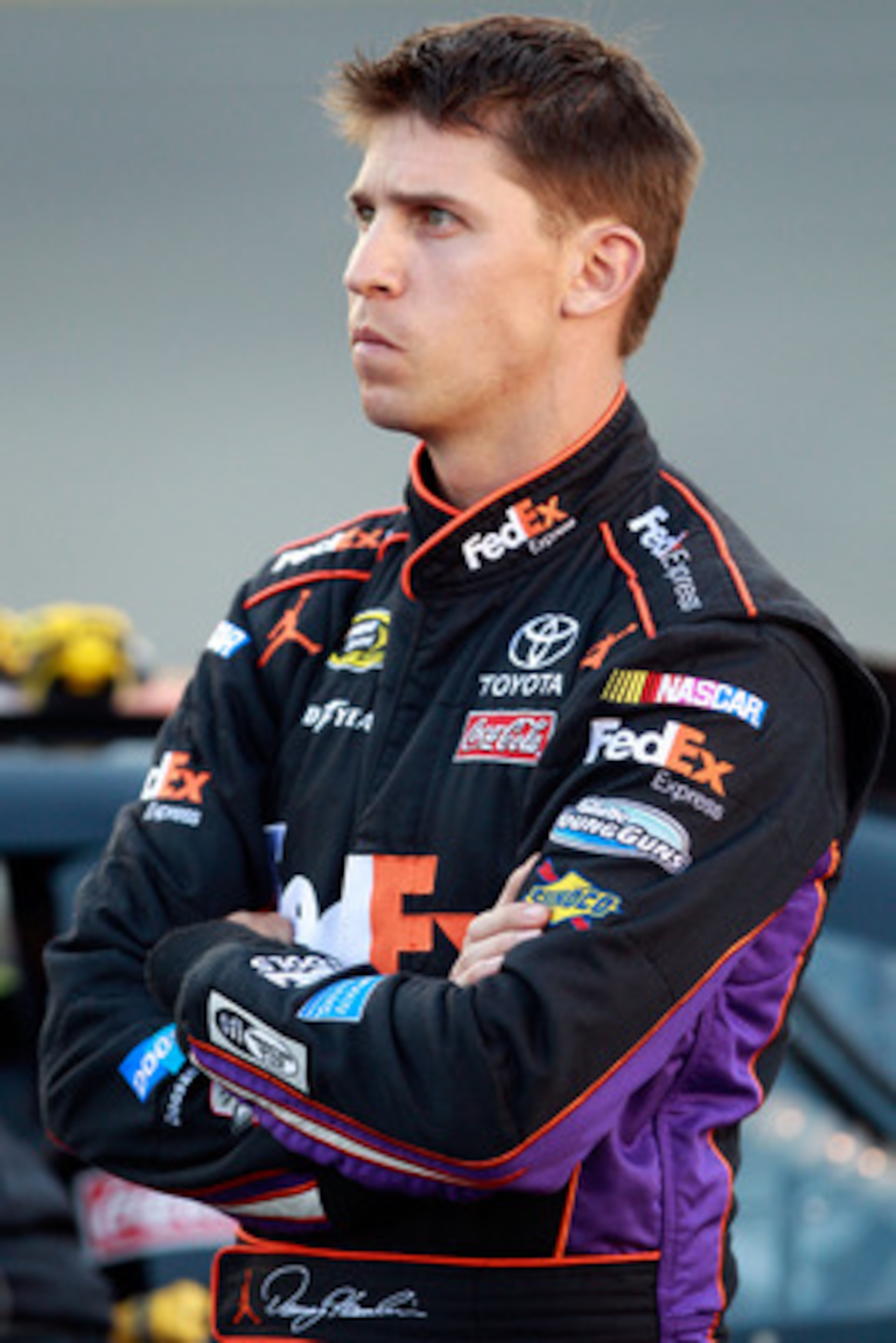 CHARLOTTE, NC - MAY 26:  Denny Hamlin, driver of the #11 FedEx Express Toyota, stands on the grid during qualifying for the NASCAR Sprint Cup Series Coca-Cola 600 at Charlotte Motor Speedway on May 26, 2011 in Charlotte, North Carolina.  (Photo by Chris G
