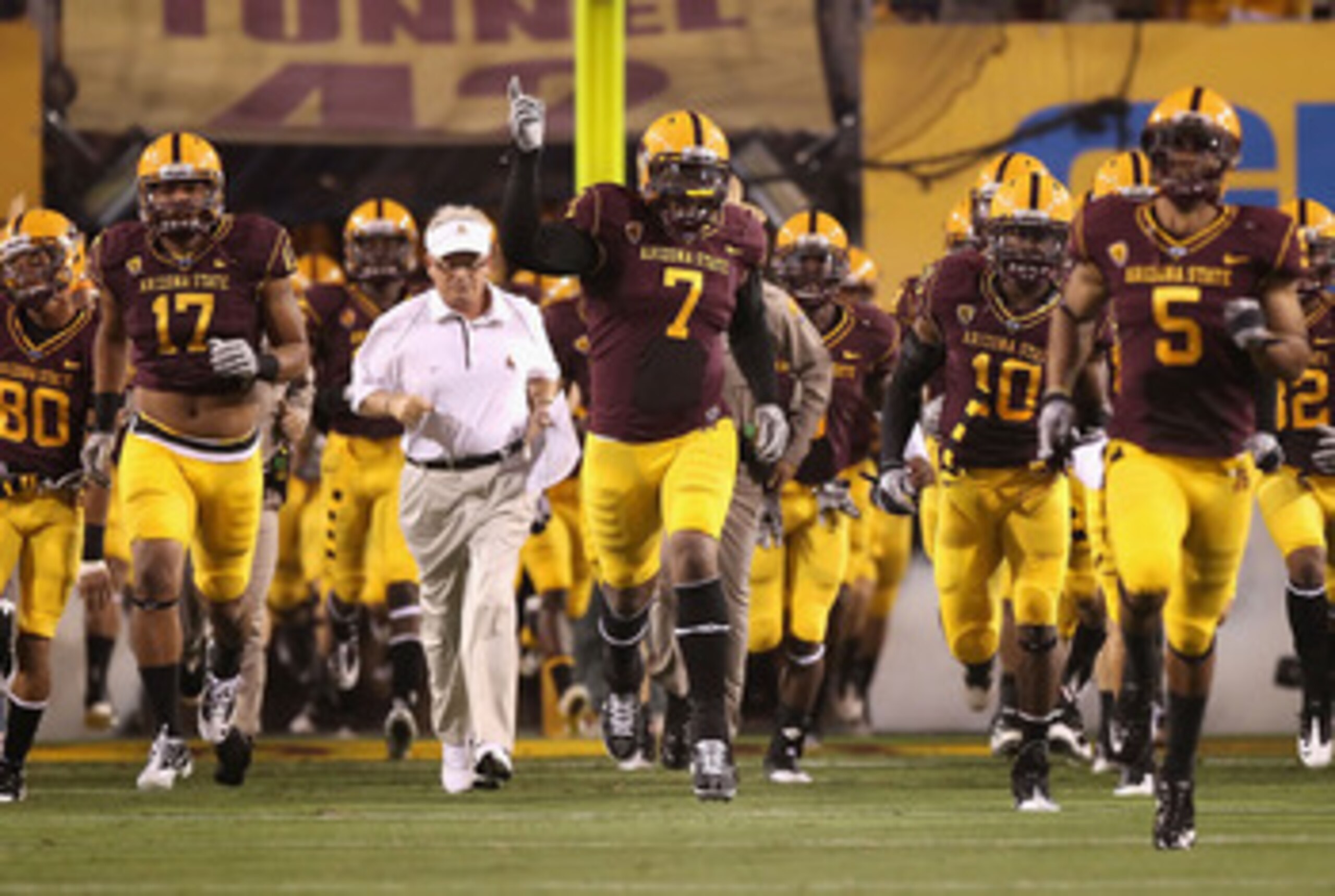 TEMPE, AZ - SEPTEMBER 04:  (L-R) Gregory Smith #17, head coach Dennis Erickson, Vontaze Burfict #7 and Keelan Johnson #10 of the Arizona State Sun Devils lead teammates out onto the field prior the college football game against the Portland State Vikings 