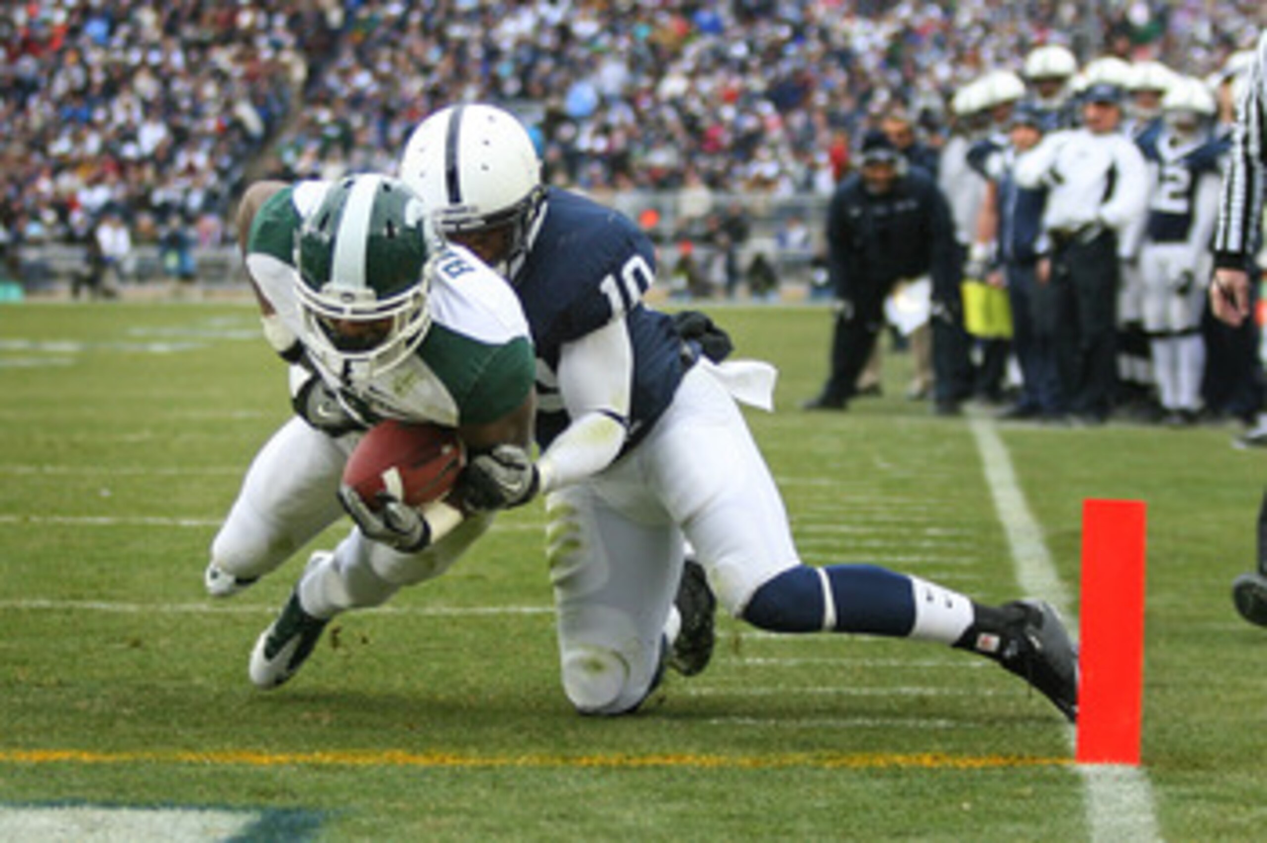 STATE COLLEGE, PA - NOVEMBER 27: Running back Edwin Baker #4 of the Michigan State Spartans runs for a touchdown as safety Malcolm Willis #10 of the Penn State Nittany Lions makes the tackle during a game on November 27, 2010 at Beaver Stadium in State Co
