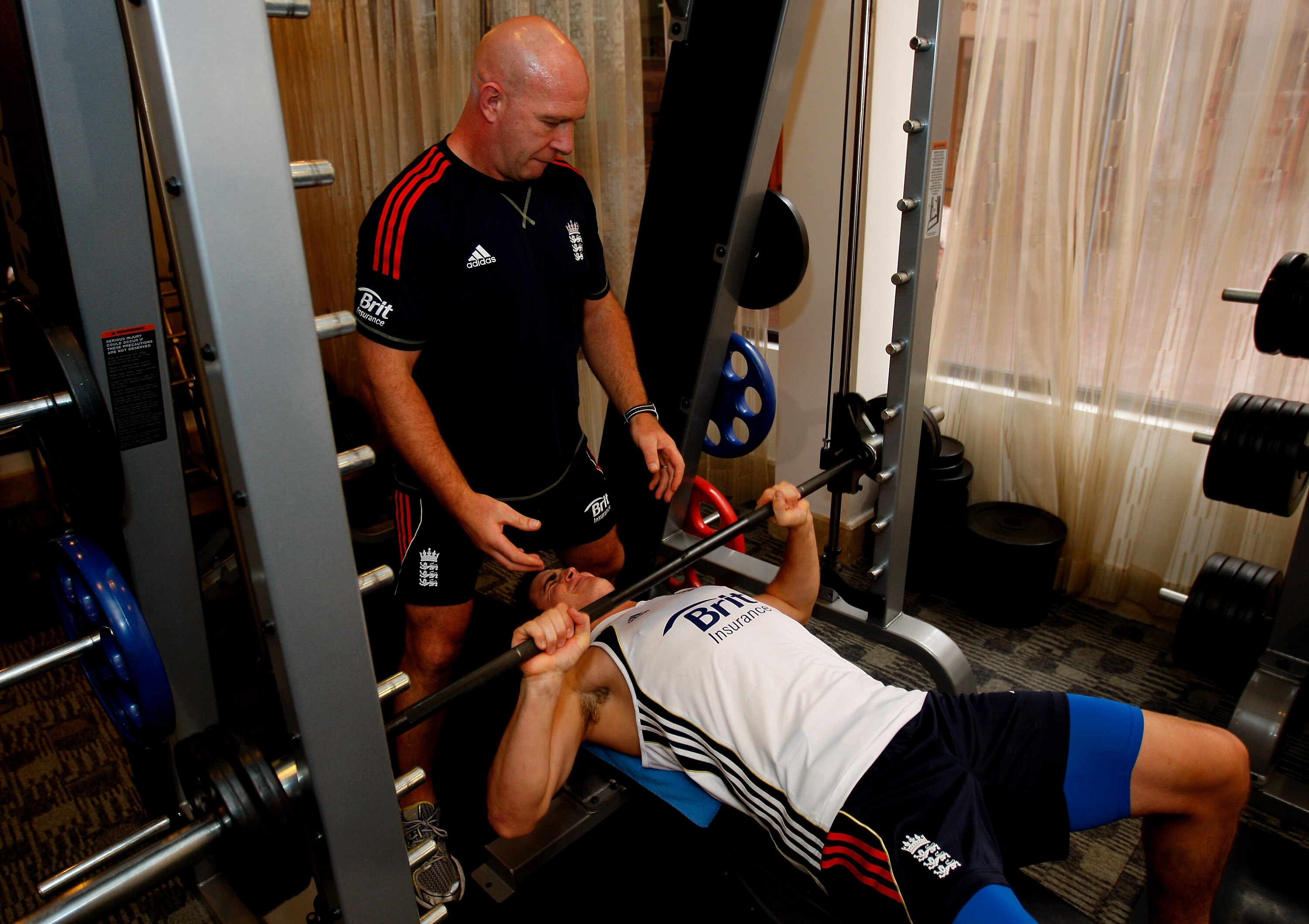 DHAKA, BANGLADESH - FEBRUARY 22:  England player Craig Kieswetter who has joined up with the team from the England Lions in Dubai, works out in the gym with the help of trainer Huw Bevan at the Pan Pacific hotel on February 22, 2010 in Dhaka, Bangladesh. 