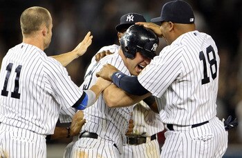 NEW YORK, NY - MAY 24:  Mark Teixeira #25 of the New York Yankees celebrates with Brett Gardner #11 and Andruw Jones #18 after hitting a game winning RBI in the ninth inning against the Toronto Blue Jays at Yankee Stadium on May 24, 2011 in the Bronx boro