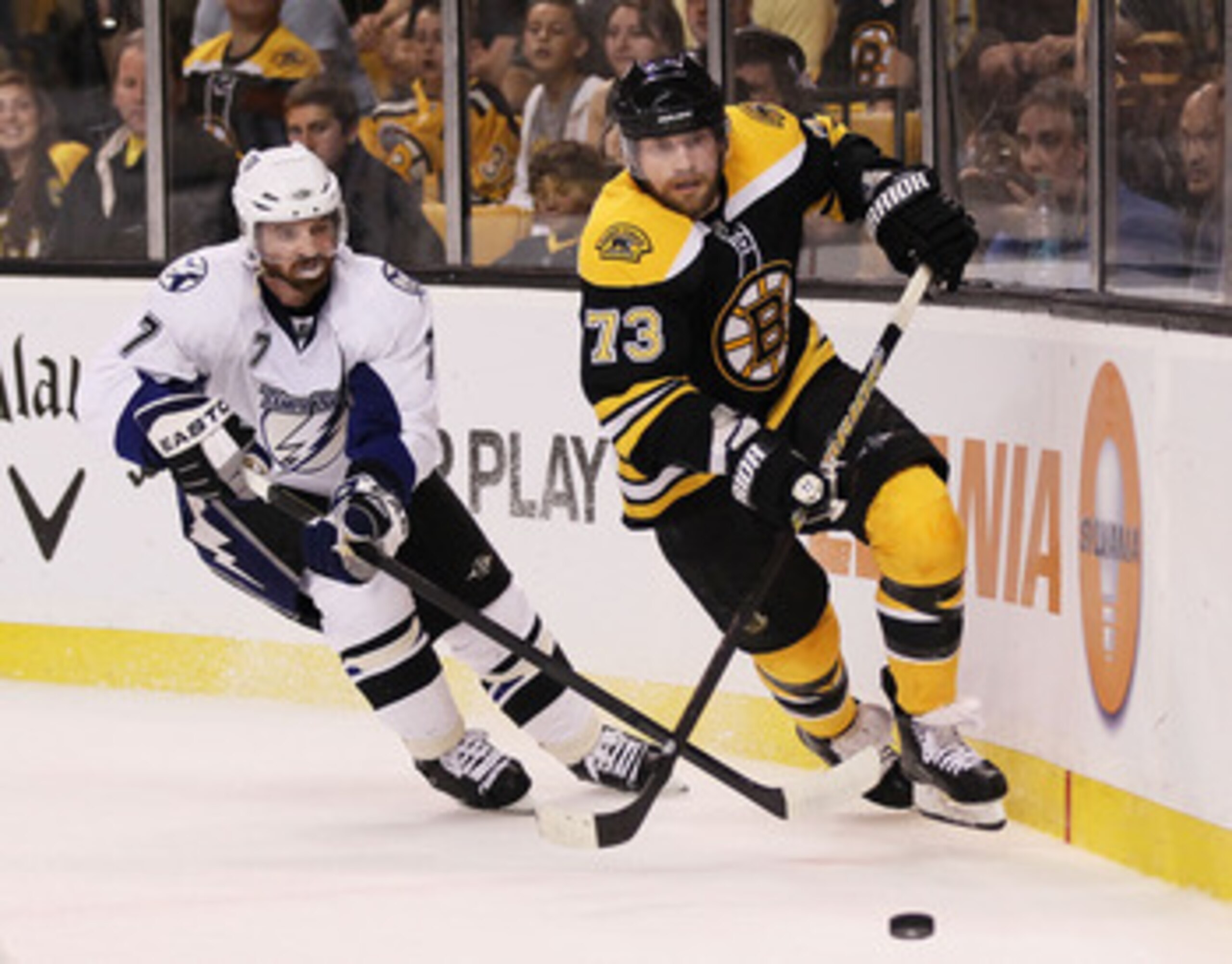 BOSTON, MA - MAY 27: Brett Clark #7 of the Tampa Bay Lightning and Michael Ryder #73 of the Boston Bruins vie for the puck in the first period of Game Seven of the Eastern Conference Finals during the 2011 NHL Stanley Cup Playoffs at TD Garden on May 27, 