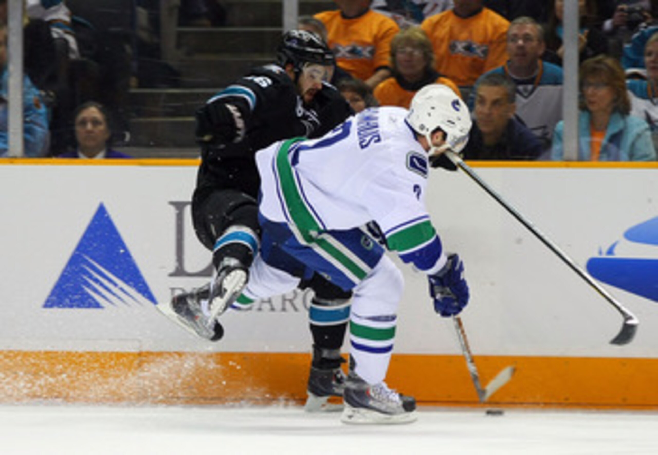 SAN JOSE, CA - MAY 20:  Dan Hamhuis #2 of the Vancouver Canucks checks Devin Setoguchi #16 of the San Jose Sharks in the first period in Game Three of the Western Conference Finals during the 2011 Stanley Cup Playoffs at HP Pavilion on May 20, 2011 in San