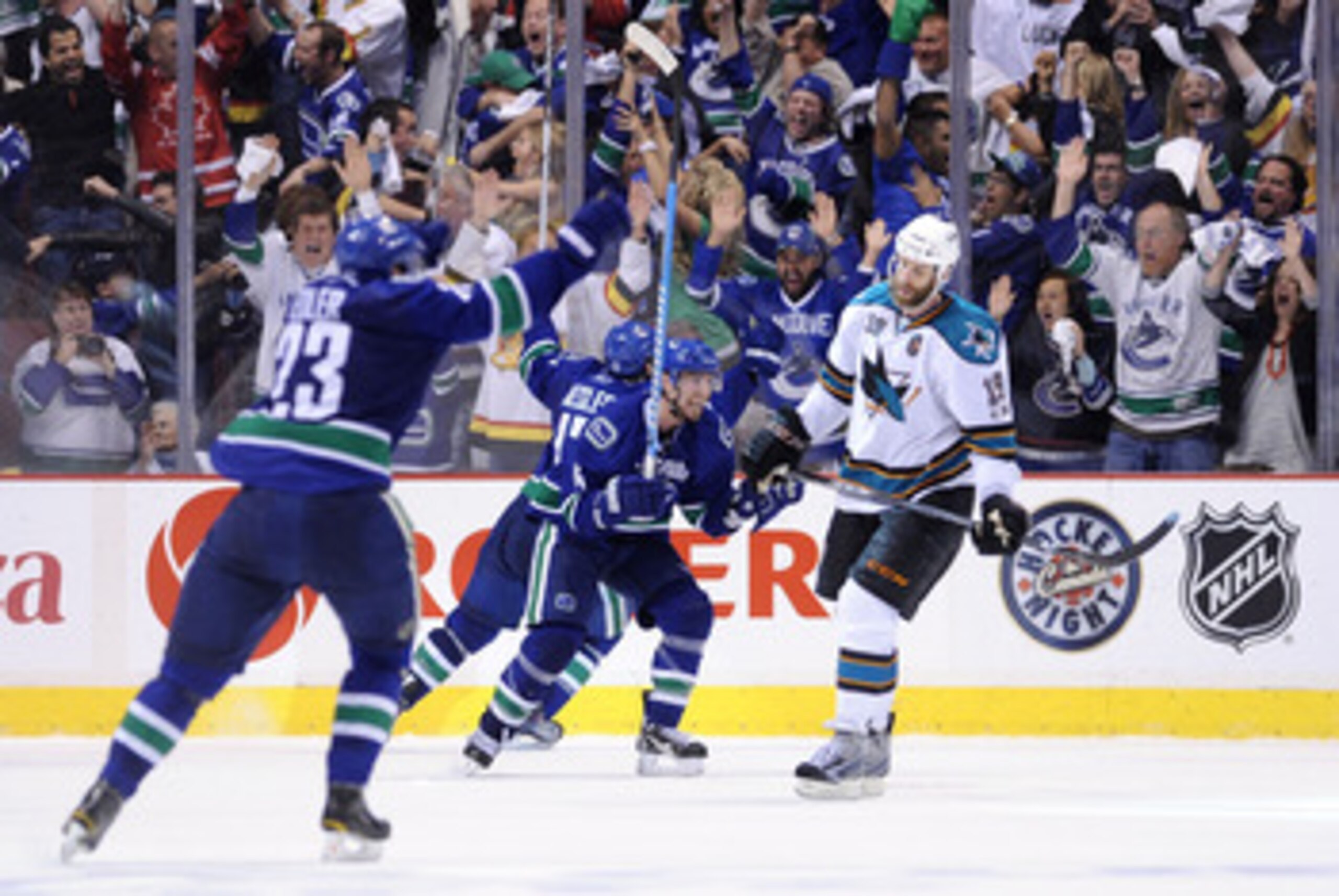 VANCOUVER, CANADA - MAY 24:  (L-R) Alexander Edler #23, Ryan Kesler #17 and Alex Burrows #14 of the Vancouver Canucks celebrate Kesler's game-tying goal at 2-2 with less than 14 seconds in the third period to send the game into overtime as Joe Thornton #1