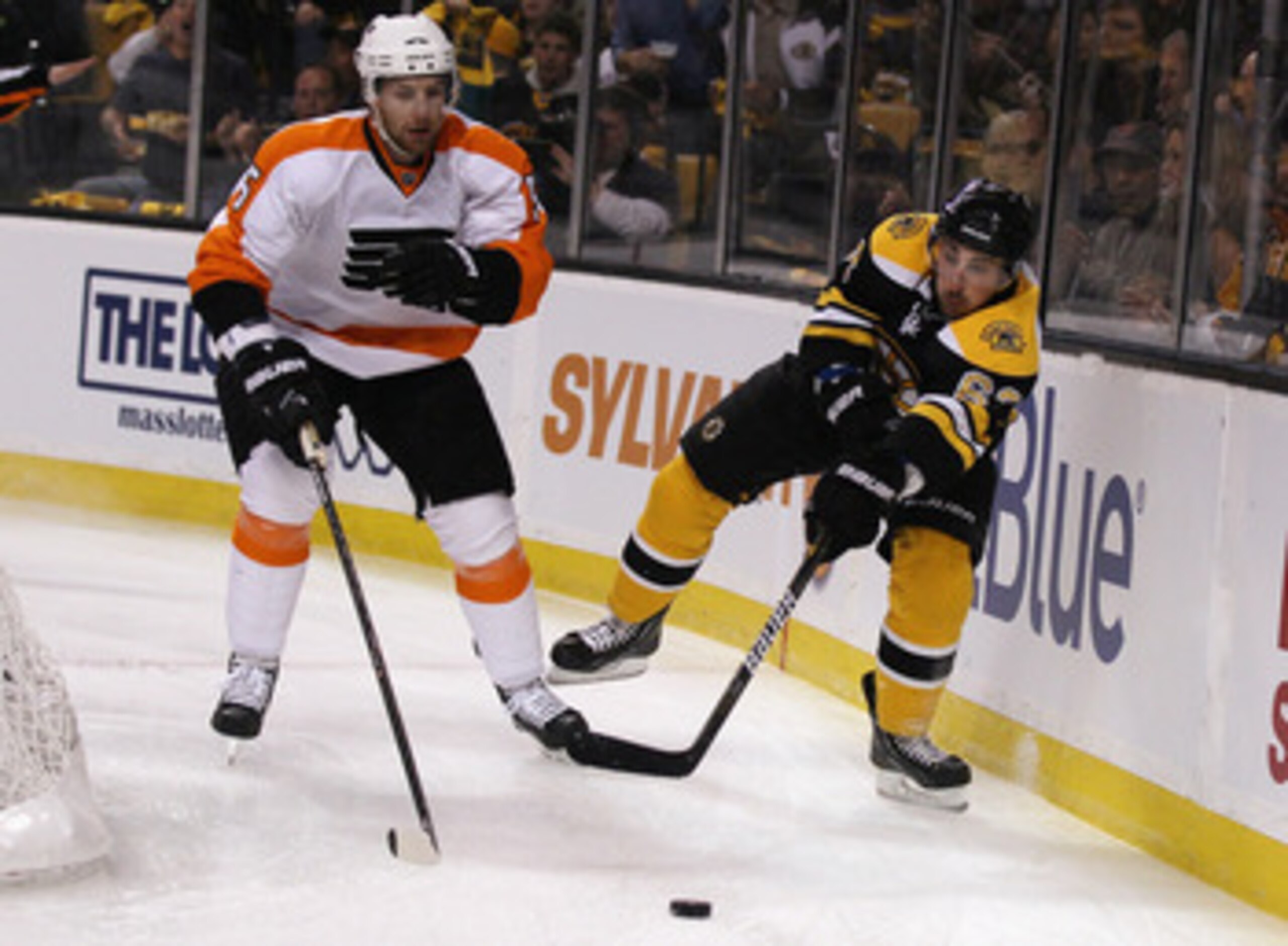BOSTON, MA - MAY 04:  Brad Marchand #63 of the Boston Bruins passes the puck as Braydon Coburn #5 of the Philadelphia Flyers defends in Game Three of the Eastern Conference Semifinals during the 2011 NHL Stanley Cup Playoffs at TD Garden on May 4 , 2011 i