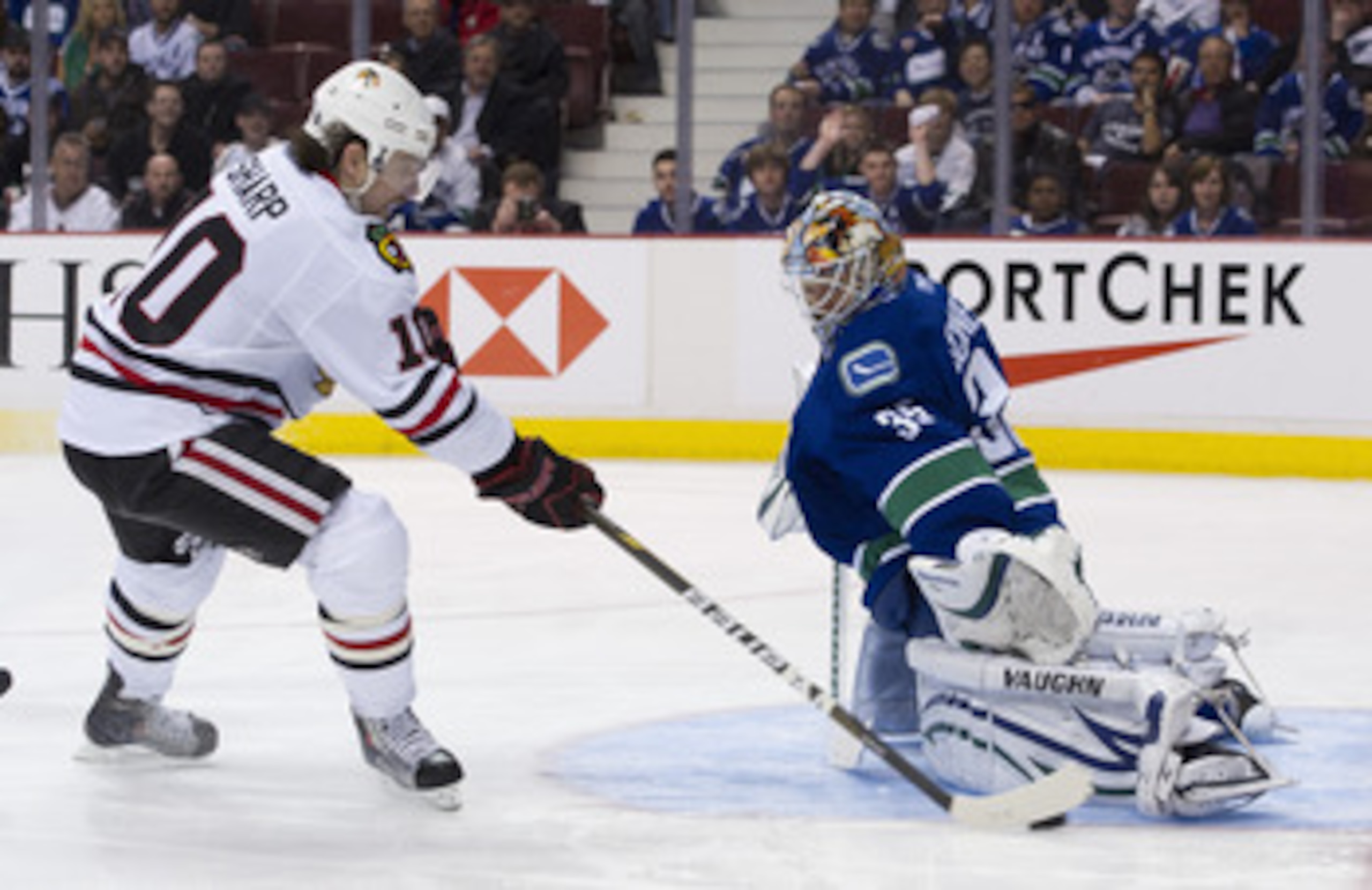 VANCOUVER, CANADA - APRIL 21: Goalie Cory Schneider #35 of the Vancouver Canucks gets his pad down to stop Patrick Sharp #10 of the Chicago Blackhawks during the third period in Game Five of the Western Conference Quarterfinals during the 2011 NHL Stanley