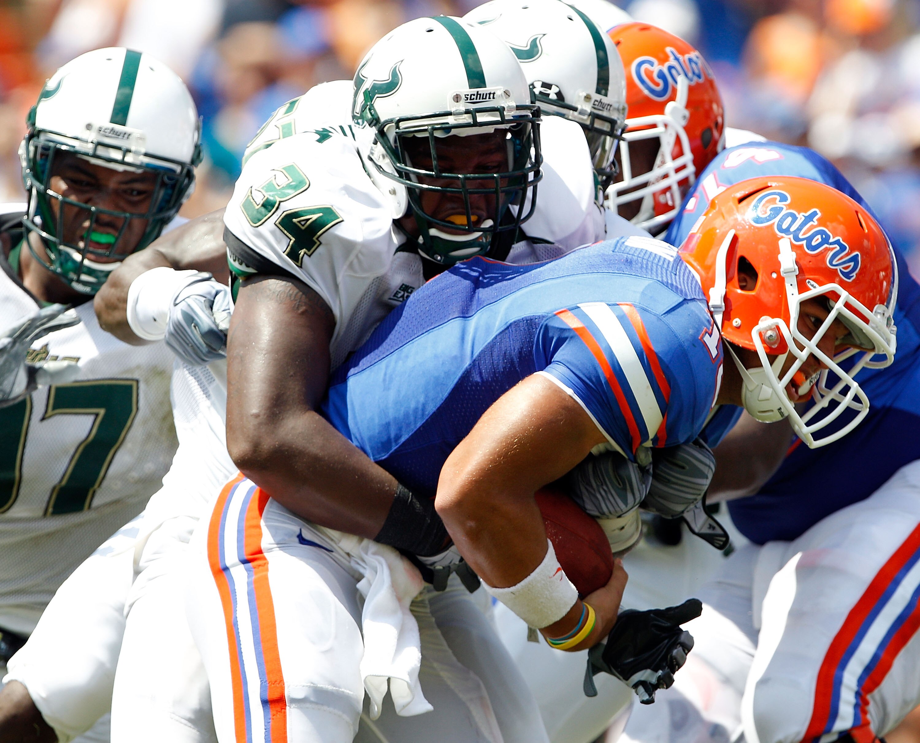 GAINESVILLE, FL - SEPTEMBER 11:  Quarterback Trey Burton #13 of the Florida Gators is tackled by Devekeyan Lattimore #34 of the South Florida Bulls  during a game at Ben Hill Griffin Stadium on September 11, 2010 in Gainesville, Florida.  (Photo by Sam Gr