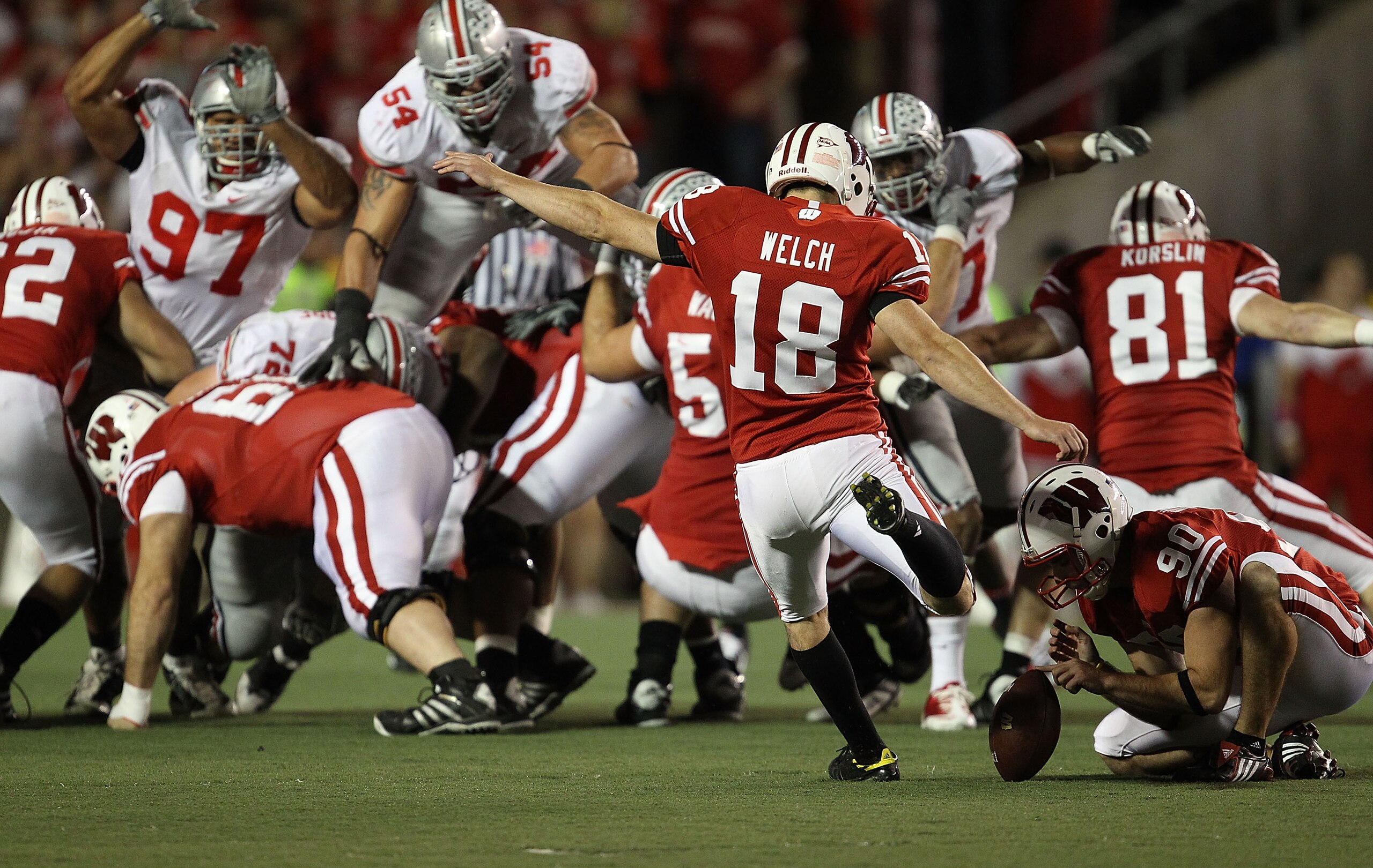 MADISON, WI - OCTOBER 16: Phillip Welch #18 of the Wisconsin Badgers kicks a field goal out of the hold of Ryan Wickesberg #90 against the Ohio State Buckeyes at Camp Randall Stadium on October 16, 2010 in Madison, Wisconsin. Wisconsin defeated Ohio State MADISON, WI - OCTOBER 16: Phillip Welch #18 of the Wisconsin Badgers kicks a field goal out of the hold of Ryan Wickesberg #90 against the Ohio State Buckeyes at Camp Randall Stadium on October 16, 2010 in Madison, Wisconsin. Wisconsin defeated Ohio State