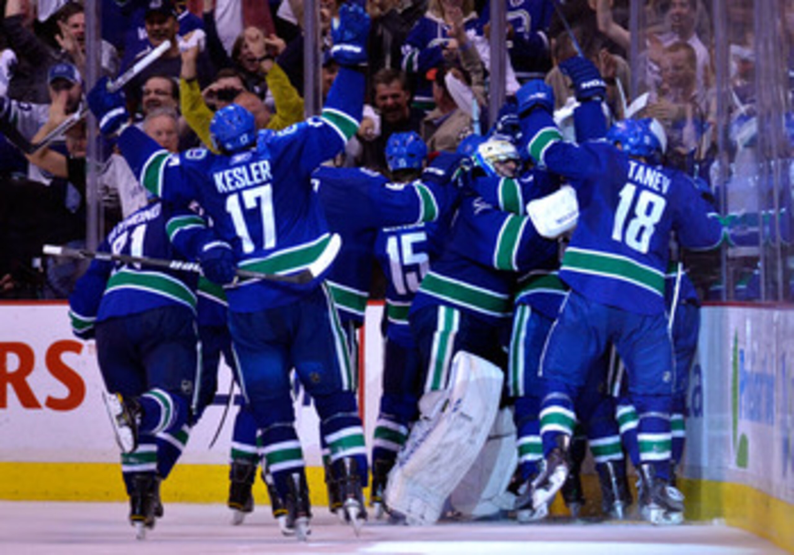 VANCOUVER, CANADA - MAY 24:  Mason Raymond #21, Ryan Kesler #17, Tanner Glass #15, goaltender Roberto Luongo #1 and Chris Tanev #18 of the Vancouver Canucks and their teammates celebrate after they defeated the San Jose Sharks 3-2 in double-overtime in Ga