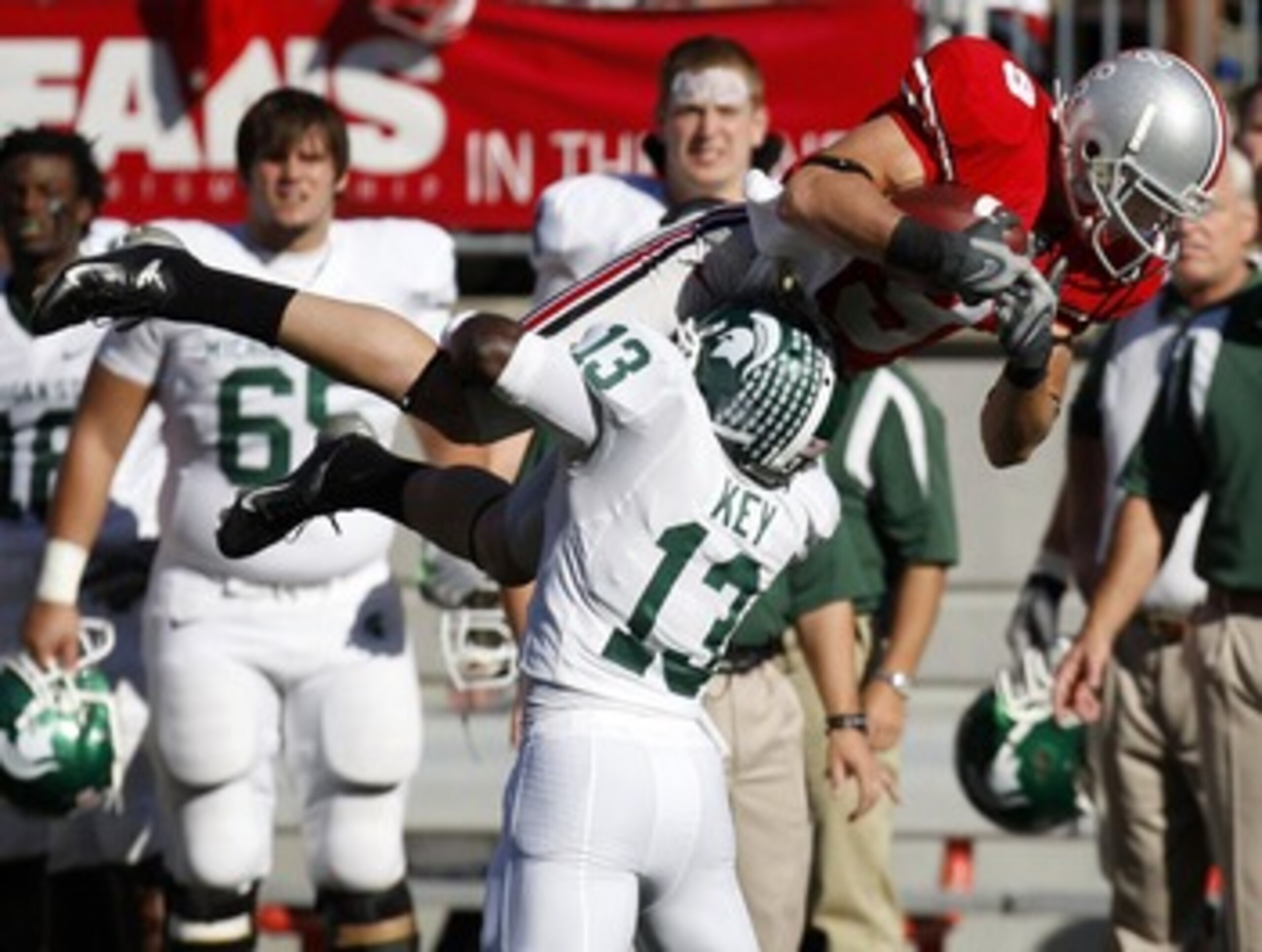 COLUMBUS, OH - OCTOBER 20:  Brian Hartline #9 of the Ohio State Buckeyes is tackled after making a first quarter catch by Travis Key #13 of the Michigan State Spartans on October 20, 2007 at Ohio Stadium in Columbus, Ohio.  (Photo by Gregory Shamus/Getty 