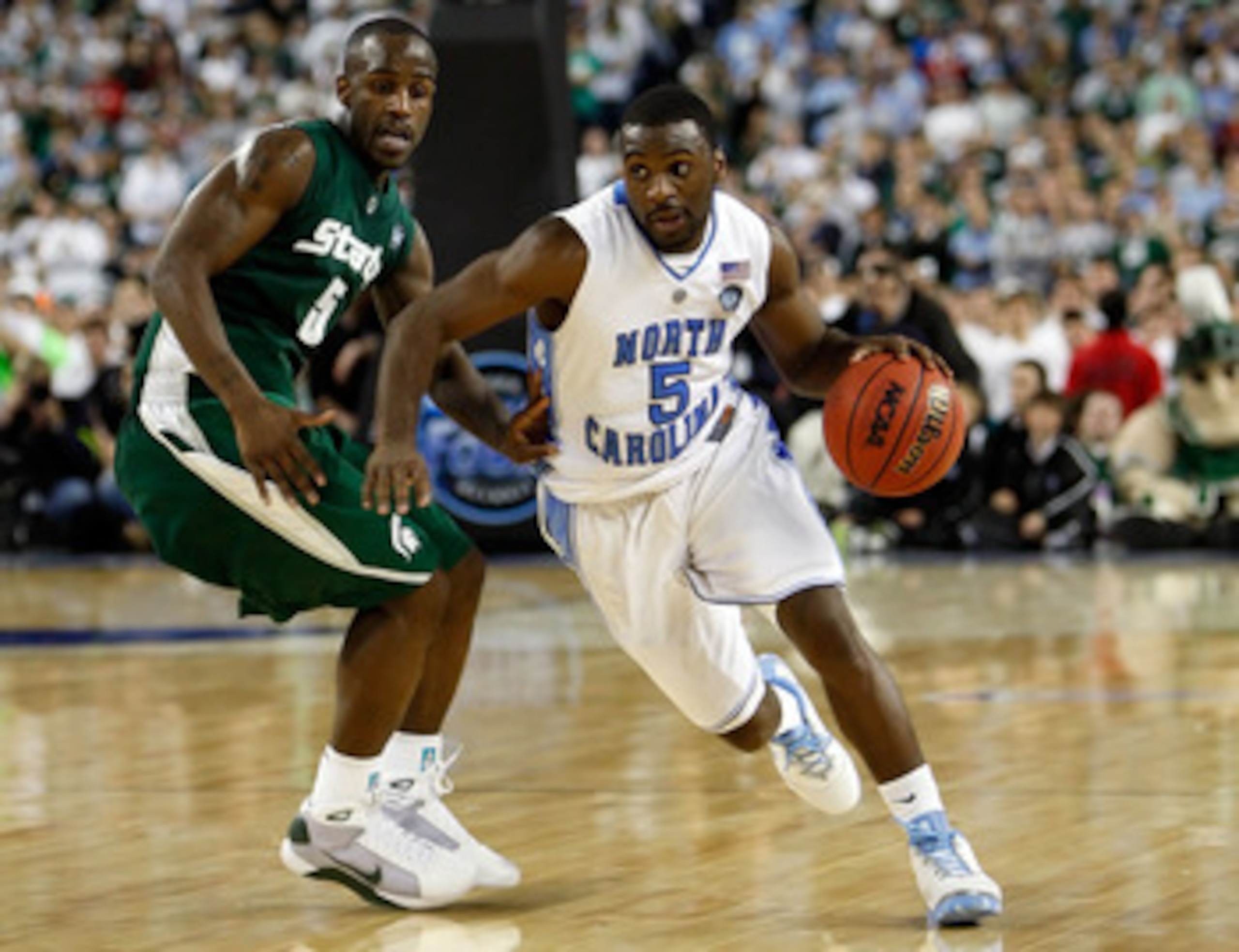 DETROIT - APRIL 06:  Ty Lawson #5 of the North Carolina Tar Heels drives on Travis Walton #5 of the Michigan State Spartans in the second half during the 2009 NCAA Division I Men's Basketball National Championship game at Ford Field on April 6, 2009 in De