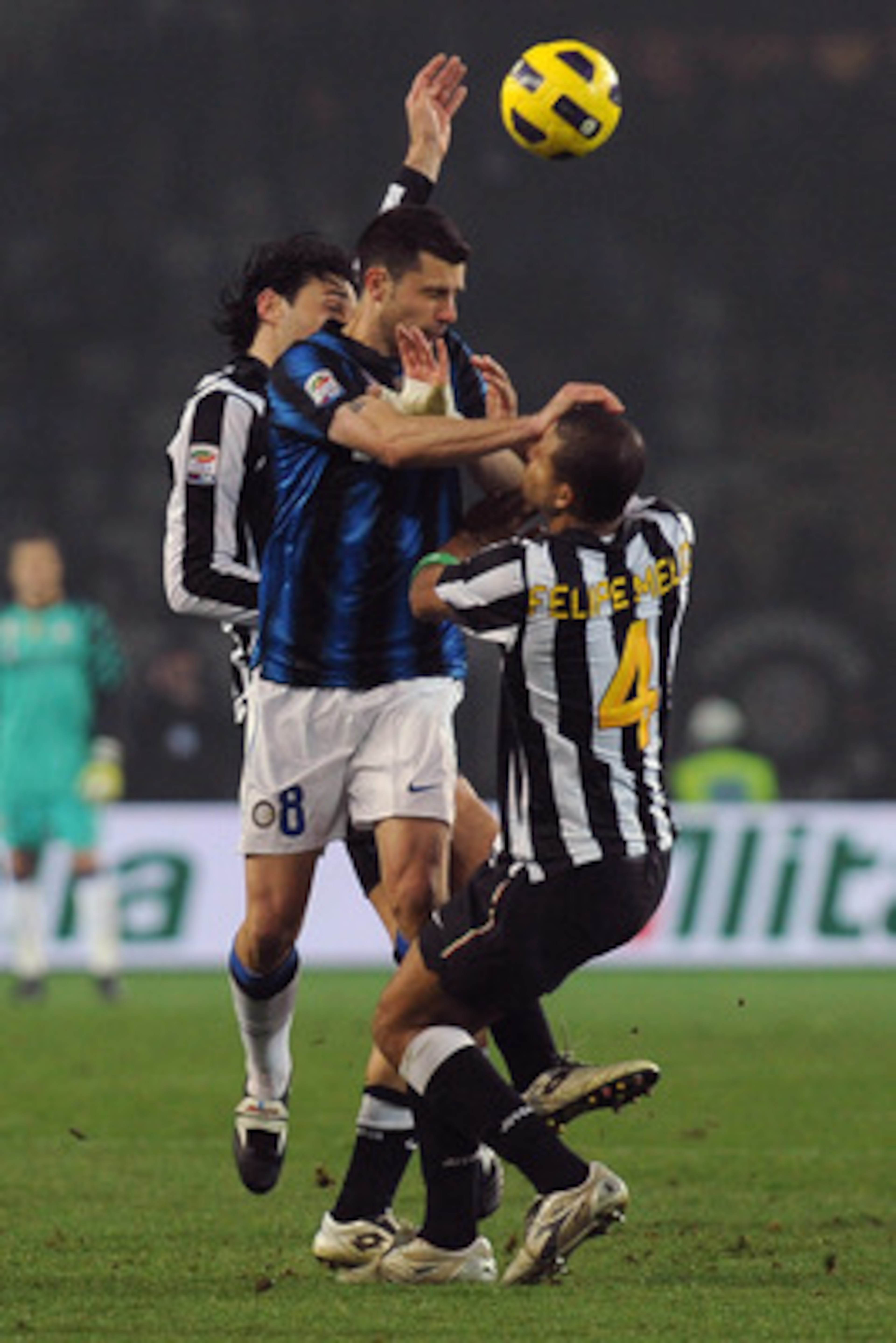 TURIN, ITALY - FEBRUARY 13:  Thiago Motta of FC Internazionale Milano clashes with Luca Toni (L) and Felipe Melo (R) of Juventus FC during the Serie A match between Juventus FC and FC Internazionale Milano at Olimpico Stadium on February 13, 2011 in Turin