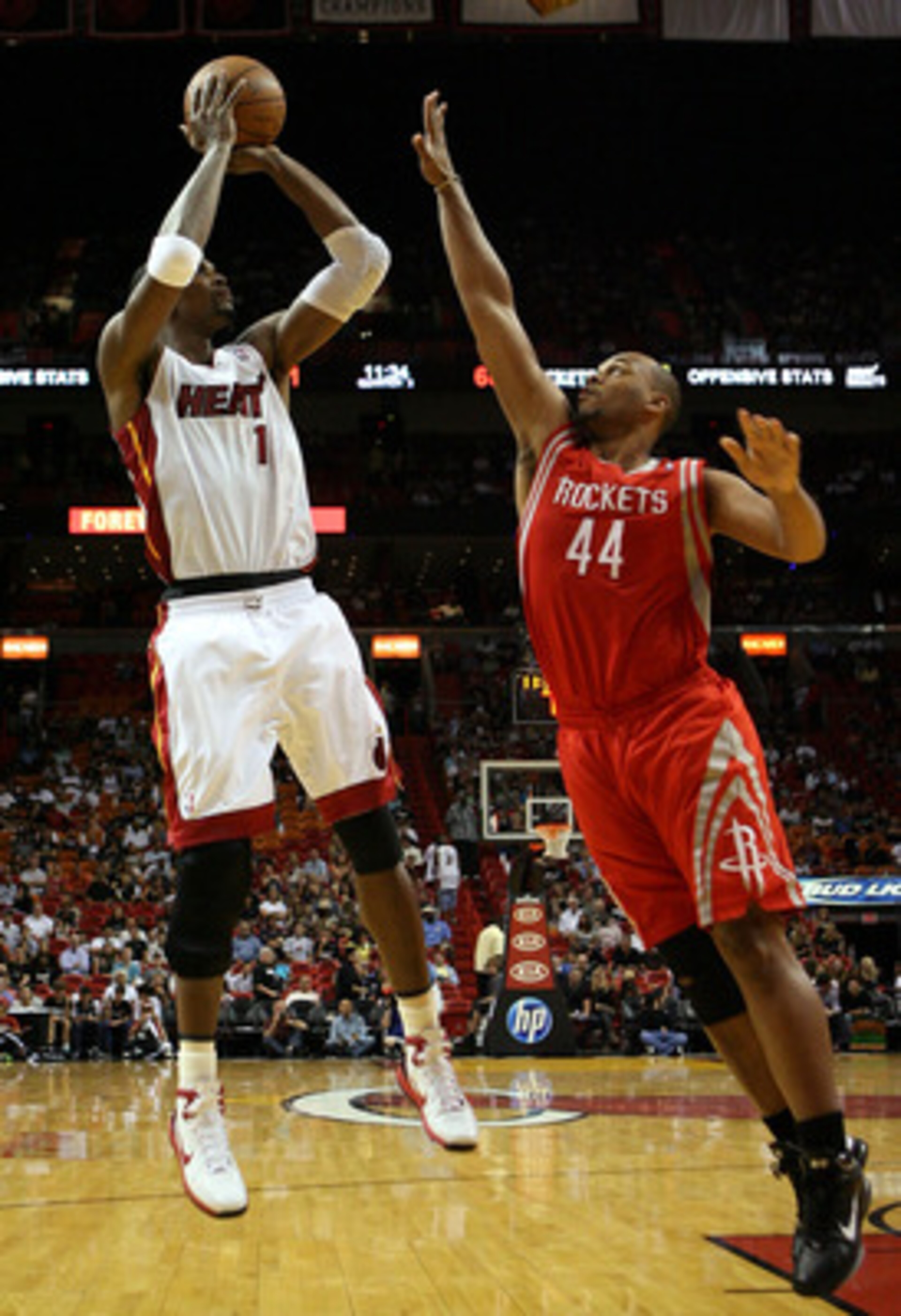 MIAMI, FL - MARCH 27:  Forward Chris Bosh #1 of the Miami Heat shoots against Center Vhuck Hayes #44 the Houston Rockets  at American Airlines Arena on March 27, 2011 in Miami, Florida. Miami defeated the Rockets 125-119. NOTE TO USER: User expressly ackn