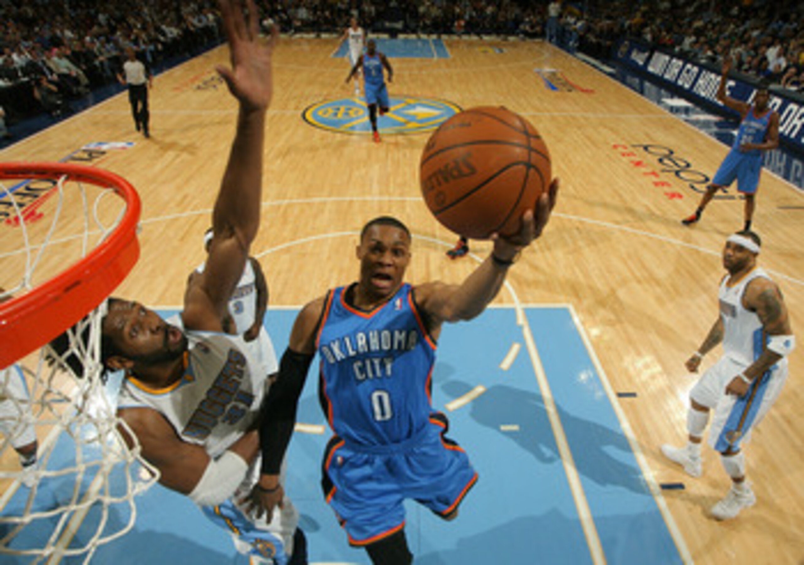 DENVER, CO - APRIL 25:  Russell Westbrook #0 of the Oklahoma City Thunder goes up for a layup as Nene #31 of the Denver Nuggets contests the shot in Game Four of the Western Conference Quarterfinals in the 2011 NBA Playoffs at Pepsi Center on April 25, 20