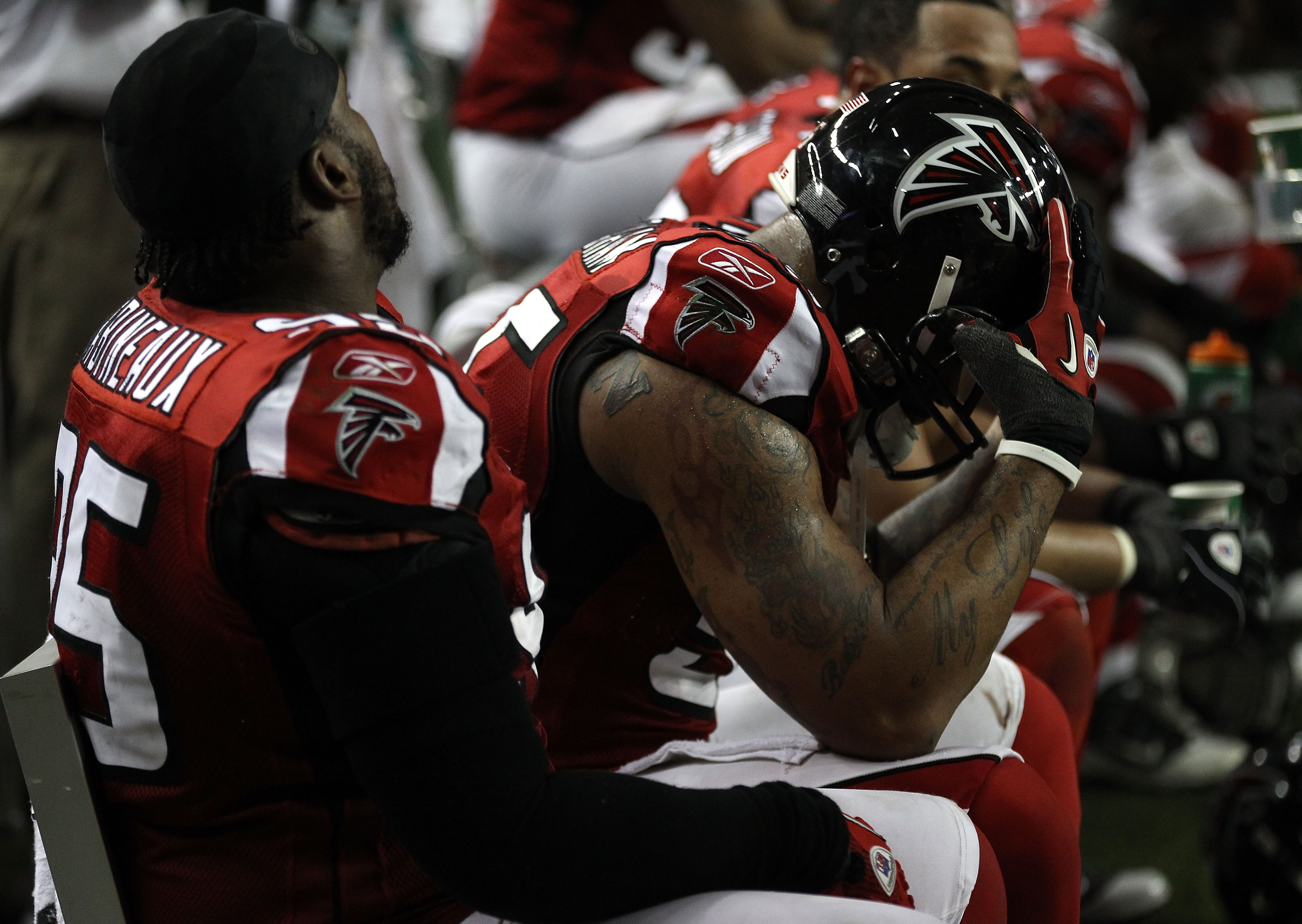 ATLANTA, GA - JANUARY 15:  Jonathan Babineaux #95 (L) and John Abraham #55 of the Atlanta Falcons sits on the bench dejected in the second half against the Green Bay Packers during their 2011 NFC divisional playoff game at Georgia Dome on January 15, 2011