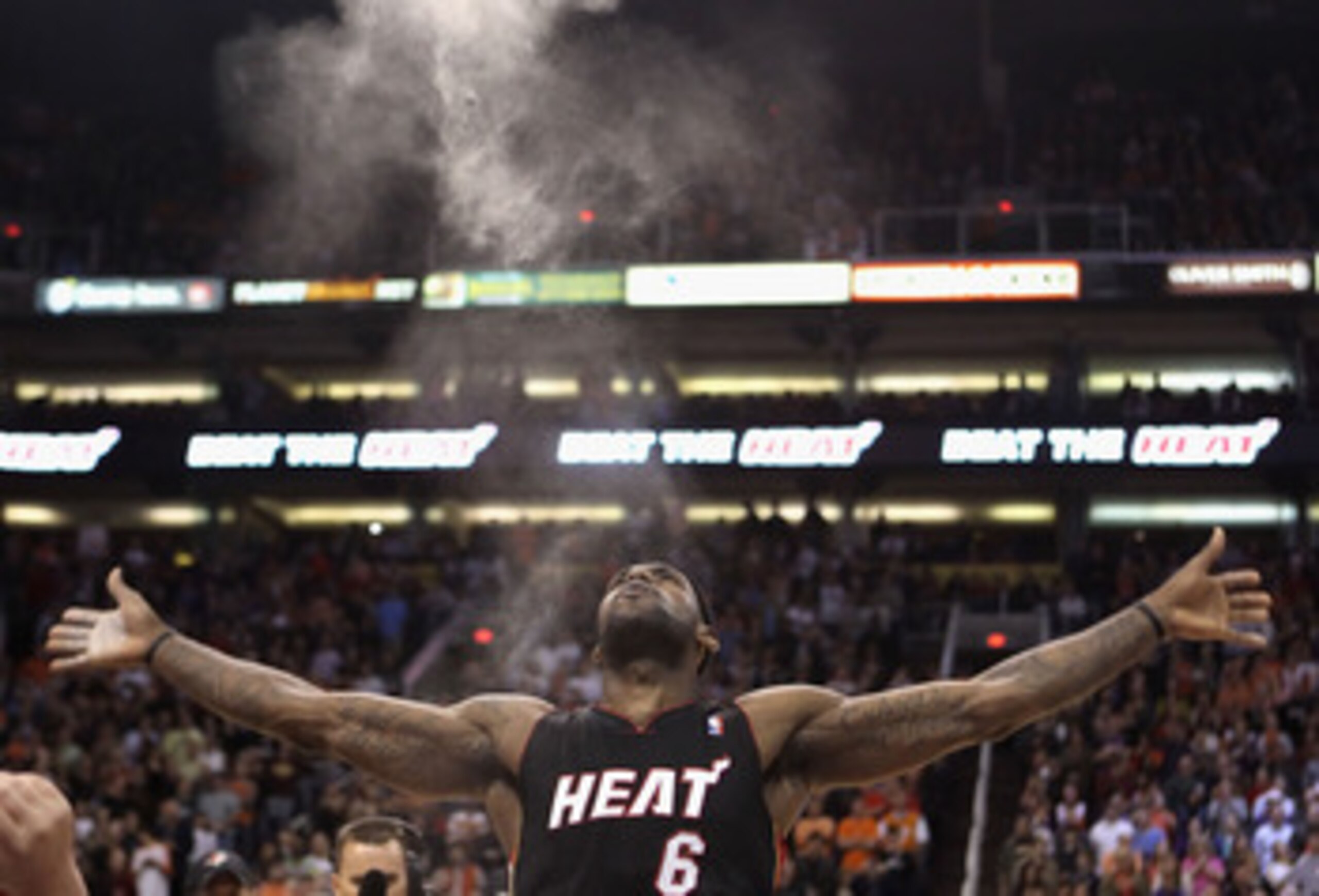 PHOENIX - DECEMBER 23:  LeBron James #6 of the Miami Heat throws chalk into the air before the NBA game against the Phoenix Suns at US Airways Center on December 23, 2010 in Phoenix, Arizona.  The Heat defeated the Suns 95-83.  NOTE TO USER: User expressl
