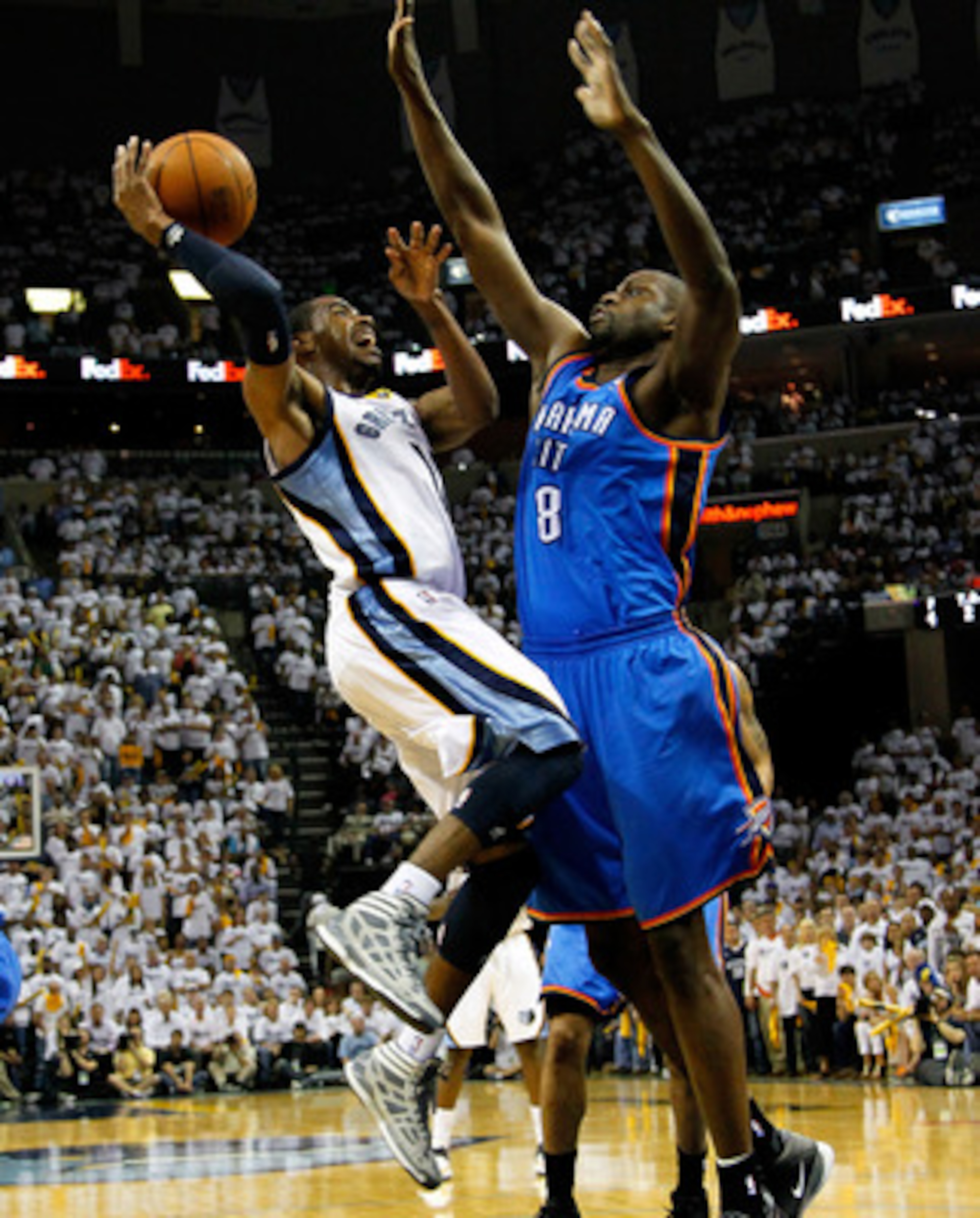 MEMPHIS, TN - MAY 13:  Mike Conley #11 of the Memphis Grizzlies shoots against Nazr Mohammed #8 of the Oklahoma City Thunder in Game Six of the Western Conference Semifinals in the 2011 NBA Playoffs at FedExForum on May 13, 2011 in Memphis, Tennessee.  NO