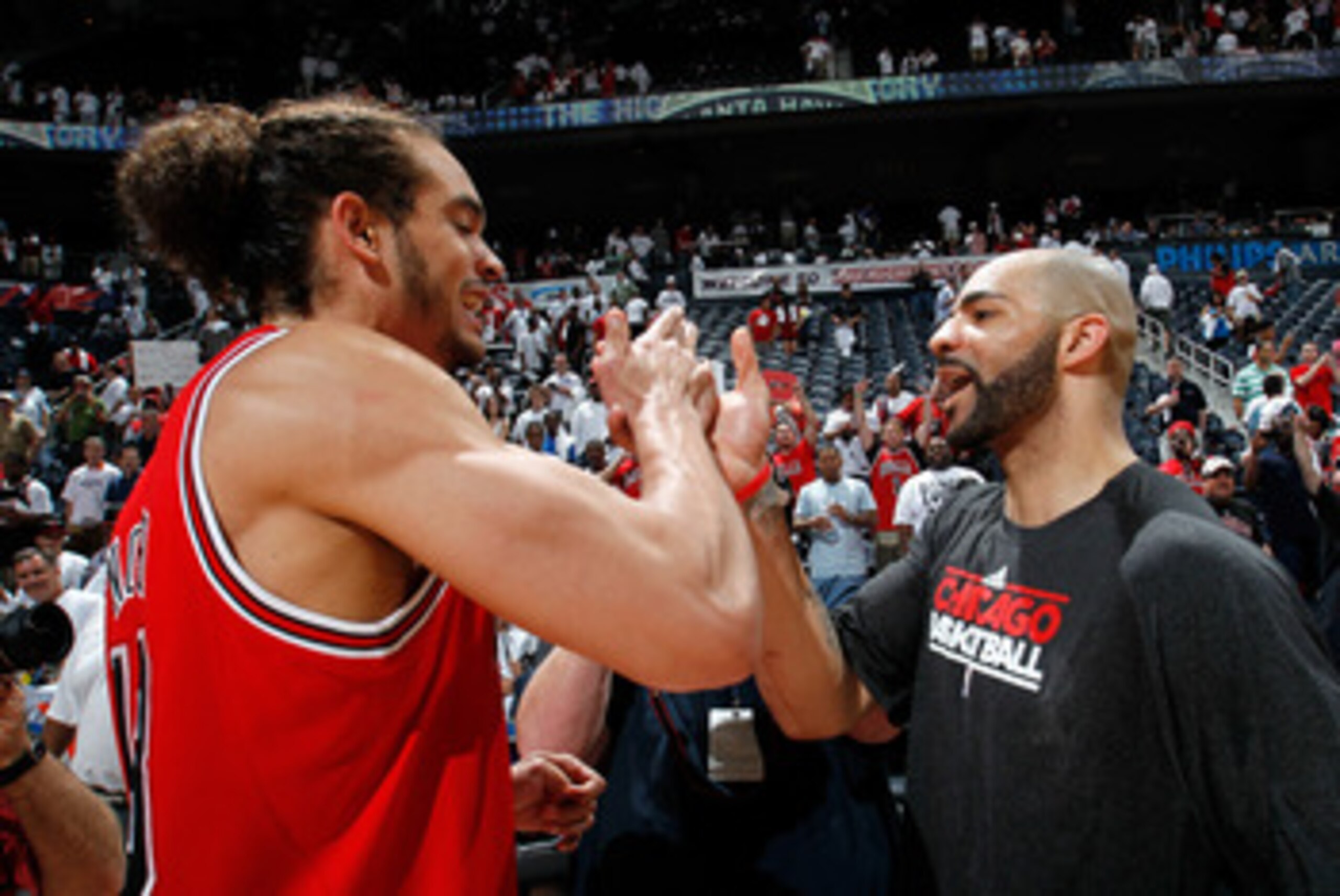 ATLANTA, GA - MAY 12:  Joakim Noah #13 and Carlos Boozer #5 of the Chicago Bulls celebrate after their 93-73 win over the Atlanta Hawks in Game Six of the Eastern Conference Semifinals in the 2011 NBA Playoffs at Phillips Arena on May 12, 2011 in Atlanta,