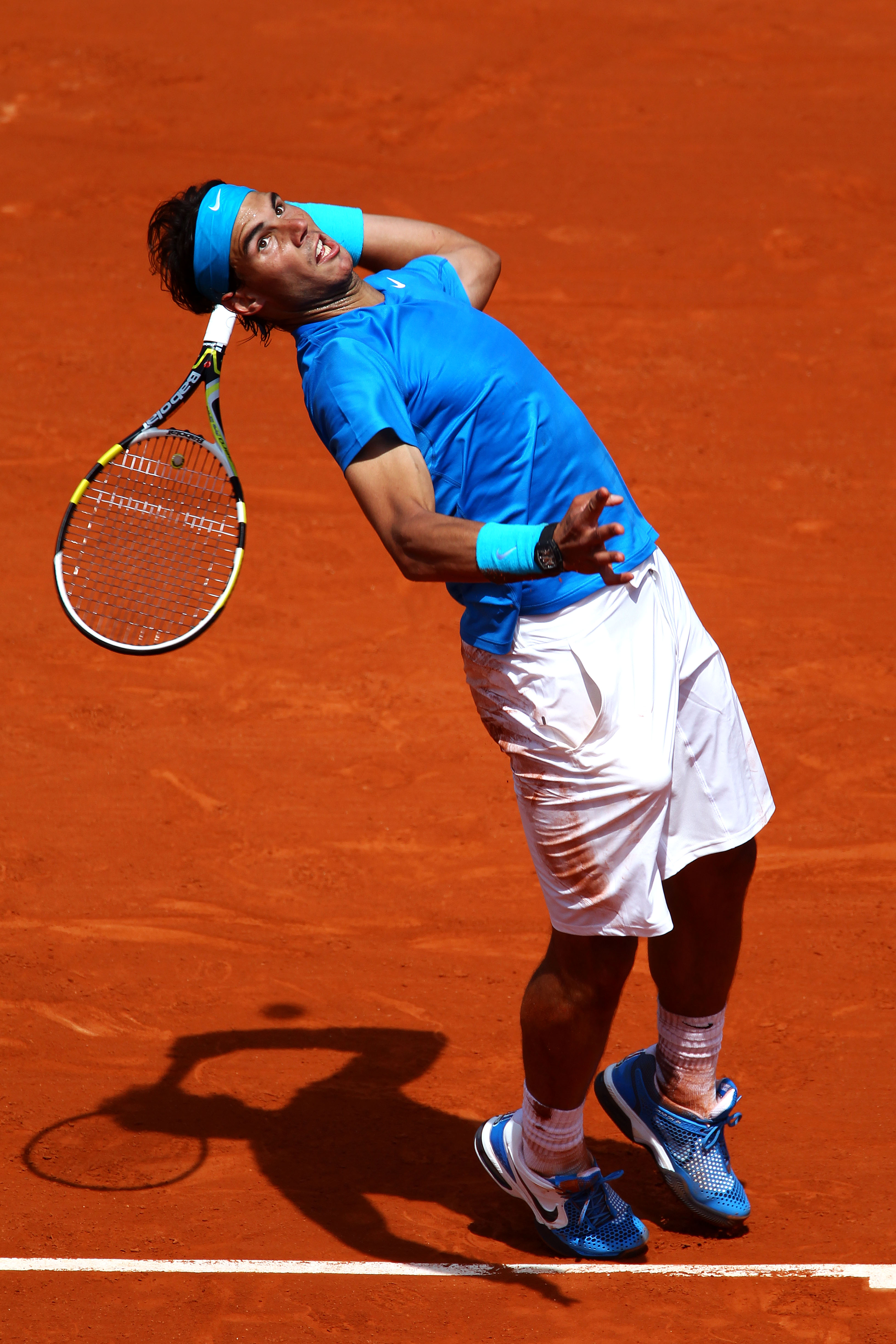 PARIS, FRANCE - MAY 28:  Rafael Nadal of Spain serves during the men's singles round three match between Rafael Nadal of Spain and Antonio Veic of Croatia on day seven of the French Open at Roland Garros on May 28, 2011 in Paris, France.  (Photo by Clive