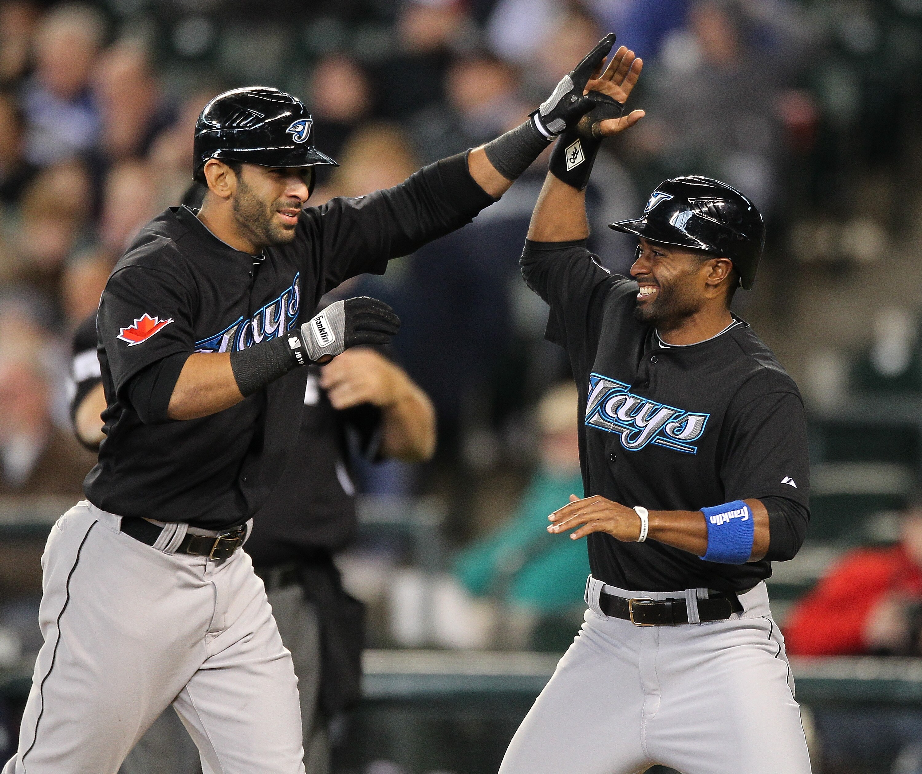 SEATTLE - APRIL 13:  Jose Bautista #19 (L) of the Toronto Blue Jays is congratulated by Corey Patterson #16 after hitting a three-run homer in the eighth inning against the Seattle Mariners at Safeco Field on April 13, 2011 in Seattle, Washington. (Photo