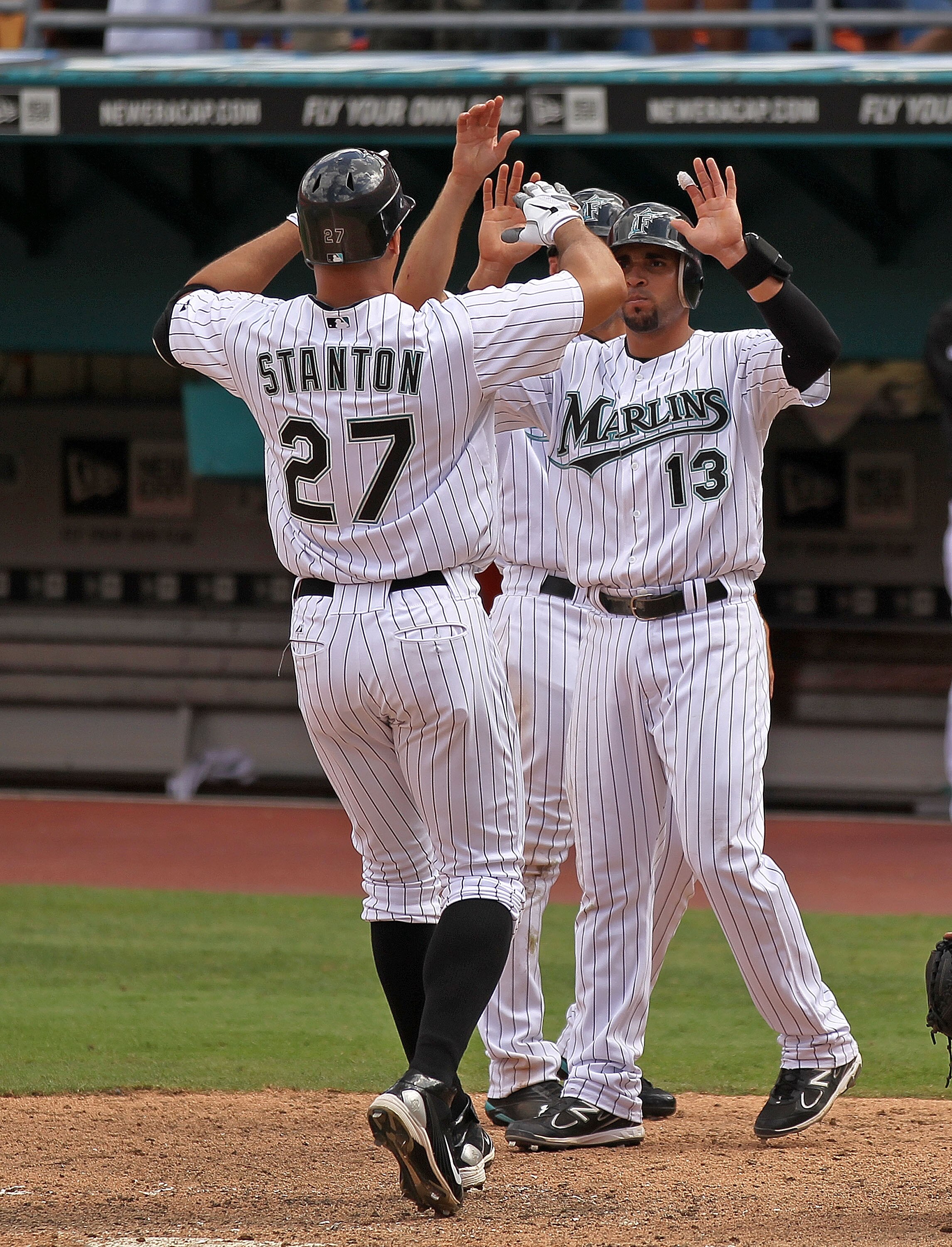 MIAMI GARDENS, FL - APRIL 24:  Mike Stanton #27 of the Florida Marlins is congratulated by Omar Infante #13 after hitting a 3 run HR during a game against the Colorado Rockies at Sun Life Stadium on April 24, 2011 in Miami Gardens, Florida.  (Photo by Mik
