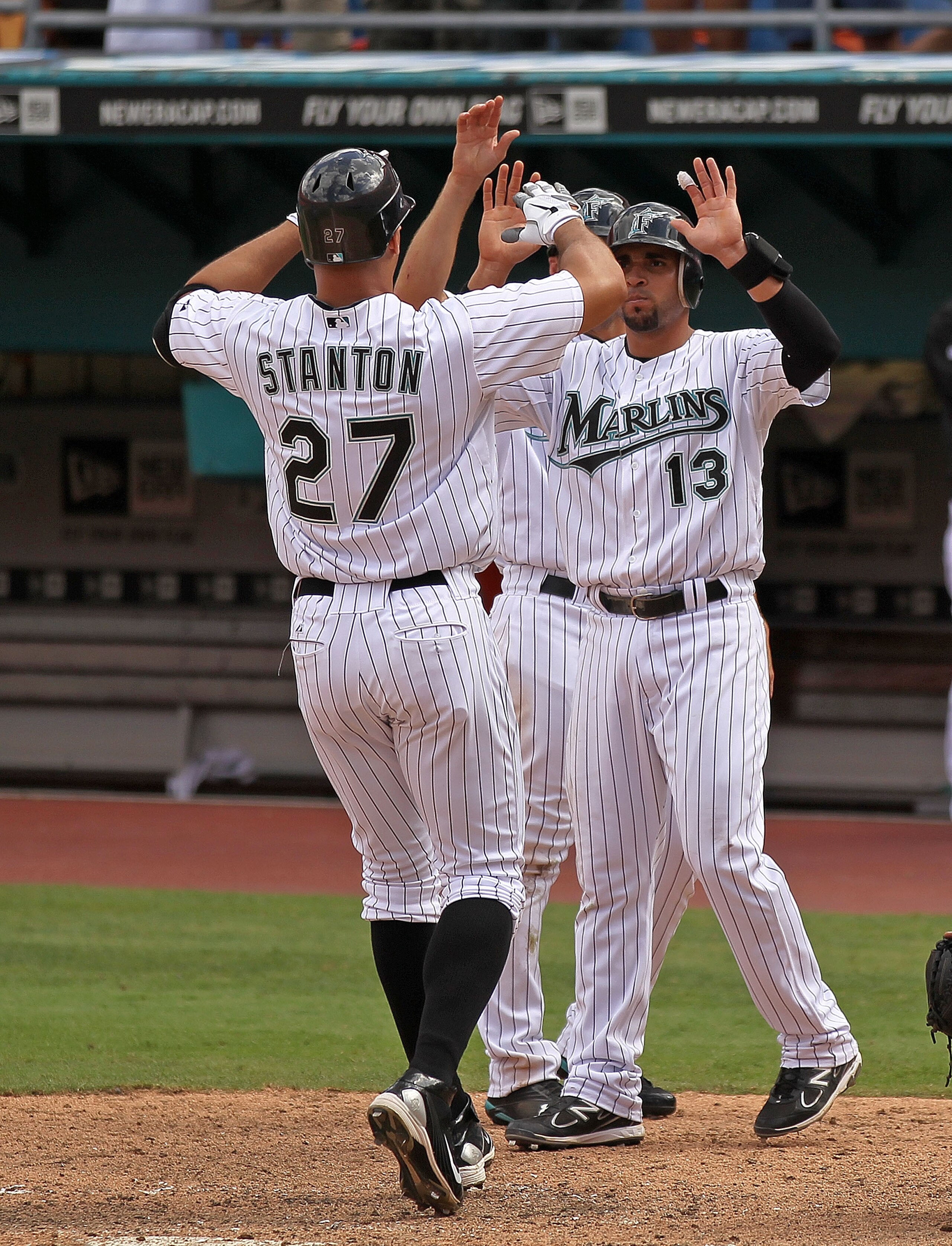 MIAMI GARDENS, FL - APRIL 24:  Mike Stanton #27 of the Florida Marlins is congratulated by Omar Infante #13 after hitting a 3 run HR during a game against the Colorado Rockies at Sun Life Stadium on April 24, 2011 in Miami Gardens, Florida.  (Photo by Mik