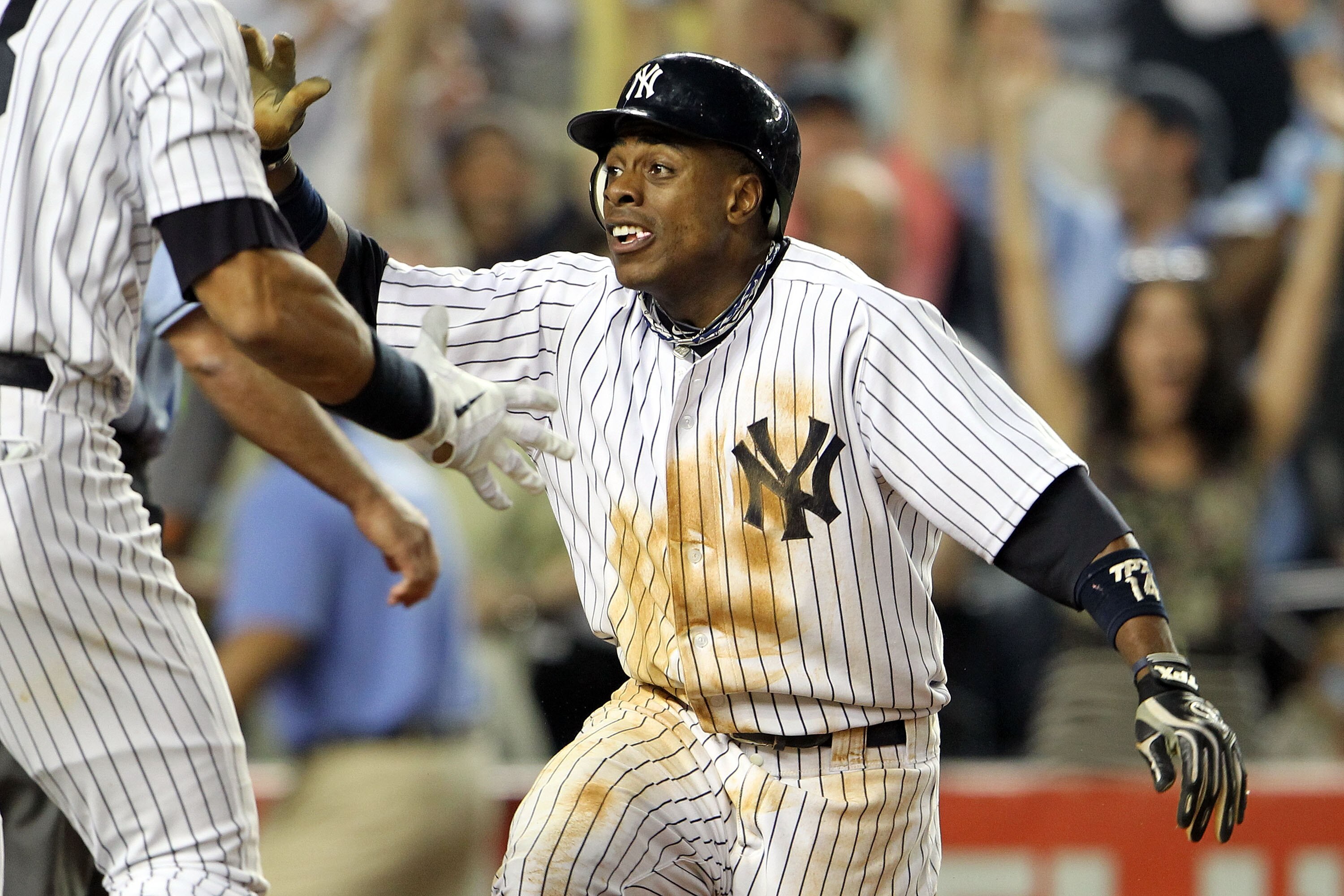 NEW YORK, NY - MAY 24:  Curtis Granderson #14 of the New York Yankees celebrates after scoring the game winning run on a Mark Teixeira #25 RBI in the ninth inning against the Toronto Blue Jays at Yankee Stadium on May 24, 2011 in the Bronx borough of New